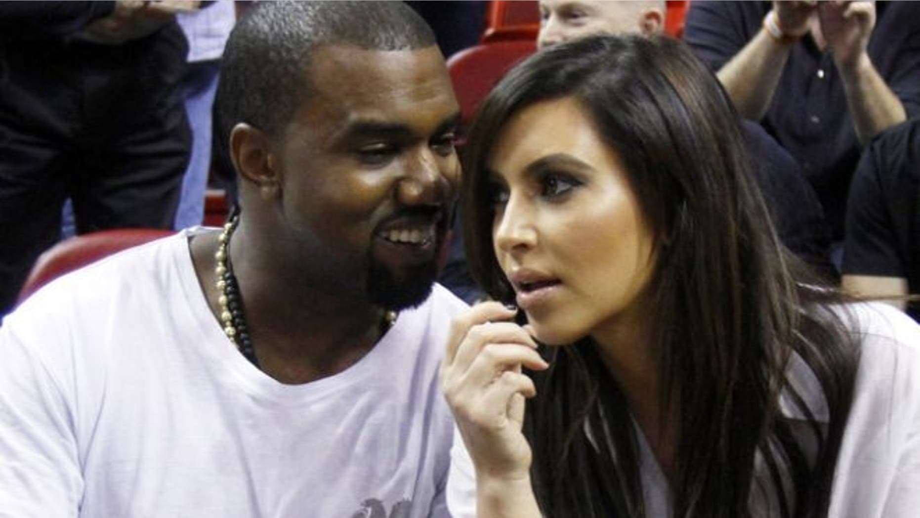 Dec. 6, 2012: Kanye West, left, talks to his girlfriend Kim Kardashian before an NBA basketball game between the Miami Heat and the New York Knicks in Miami.