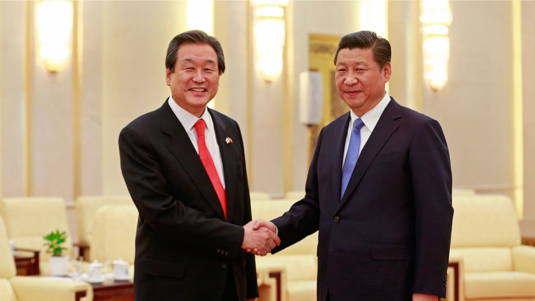 South Korean politician Kim Moo-sung (L) is seen greeting Chinese President Xi Jinging in 2014.