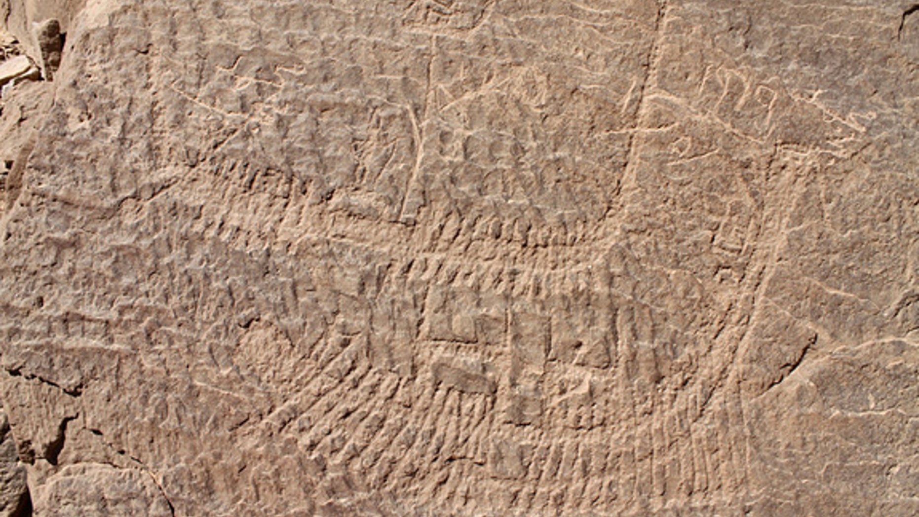 Look closely -- standing on the top of this boat is a crowned figure who may represent Narmer, the first pharaoh to rule unified Egypt. Oarsmen propel the boat along.