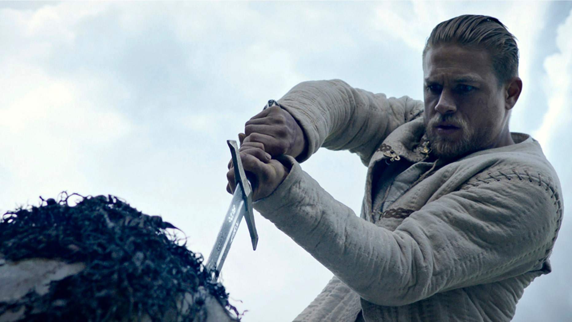 This image released by Warner Bros. Pictures shows Charlie Hunnam in a scene from, "King Arthur: Legend of the Sword." (Warner Bros. Pictures via AP)