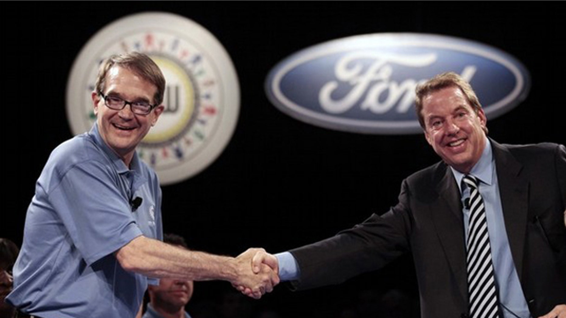 United Auto Workers Union President Bob King (L) and Ford Motor Co Executive Chairman Bill Ford shake hands to mark the beginning of labor contract negotiations at the Rouge Center in Dearborn, Michigan July 29, 2011.
