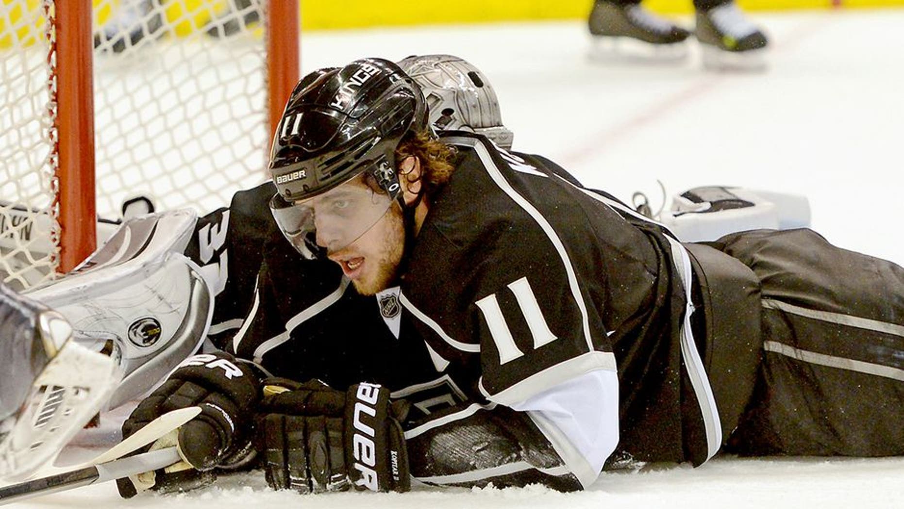 Feb 1, 2014; Los Angeles, CA, USA; Los Angeles Kings goalie Jonathan Quick (32) and center Anze Kopitar (11) lay on the ice after Philadelphia Flyers center Claude Giroux (not pictured) scored in the third period of game at Staples Center. Philadelphia Flyers won 2-0. Mandatory Credit: Jayne Kamin-Oncea-USA TODAY Sports