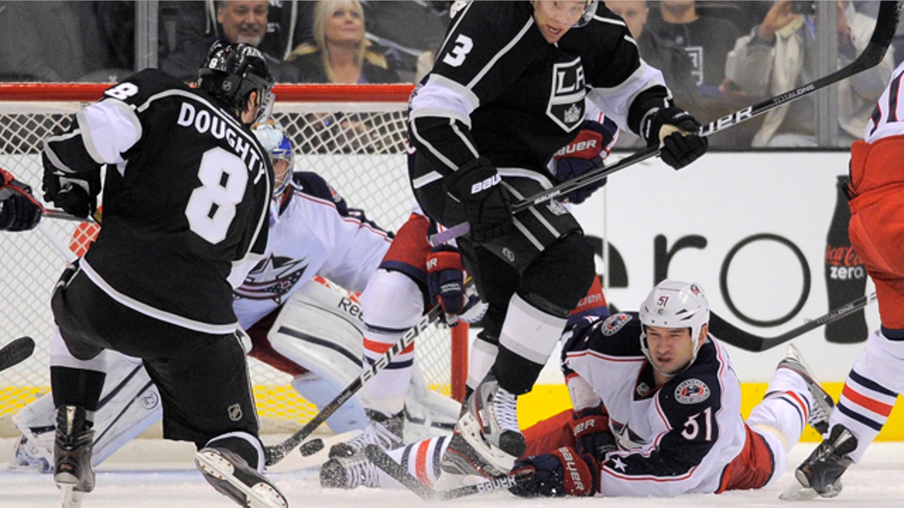 Feb. 1, 2012: Los Angeles Kings defenseman Drew Doughty, left, shoots and scores to win the game on Columbus Blue Jackets goalie Curtis Sanford, second from left, as Los Angeles Kings defenseman Jack Johnson, second from right, jumps out of the way and Columbus Blue Jackets defenseman Fedor Tyutin of Russia falls during the third period of their NHL hockey game in Los Angeles. The Kings won 3-2.