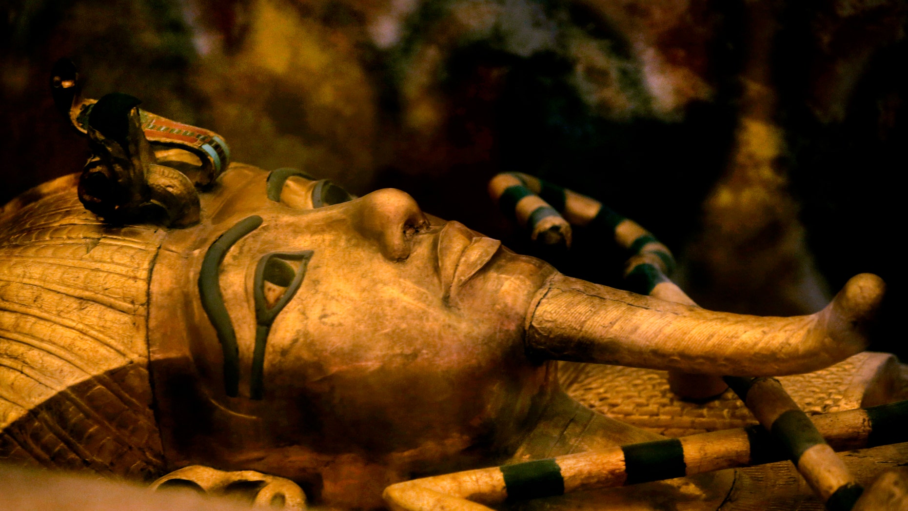 FILE - In this Thursday, Nov. 5, 2015 file photo, Egypt's famed King Tutankhamun's golden sarcophagus is displayed at his tomb in a glass case at the Valley of the Kings in Luxor. (AP Photo/Amr Nabil)