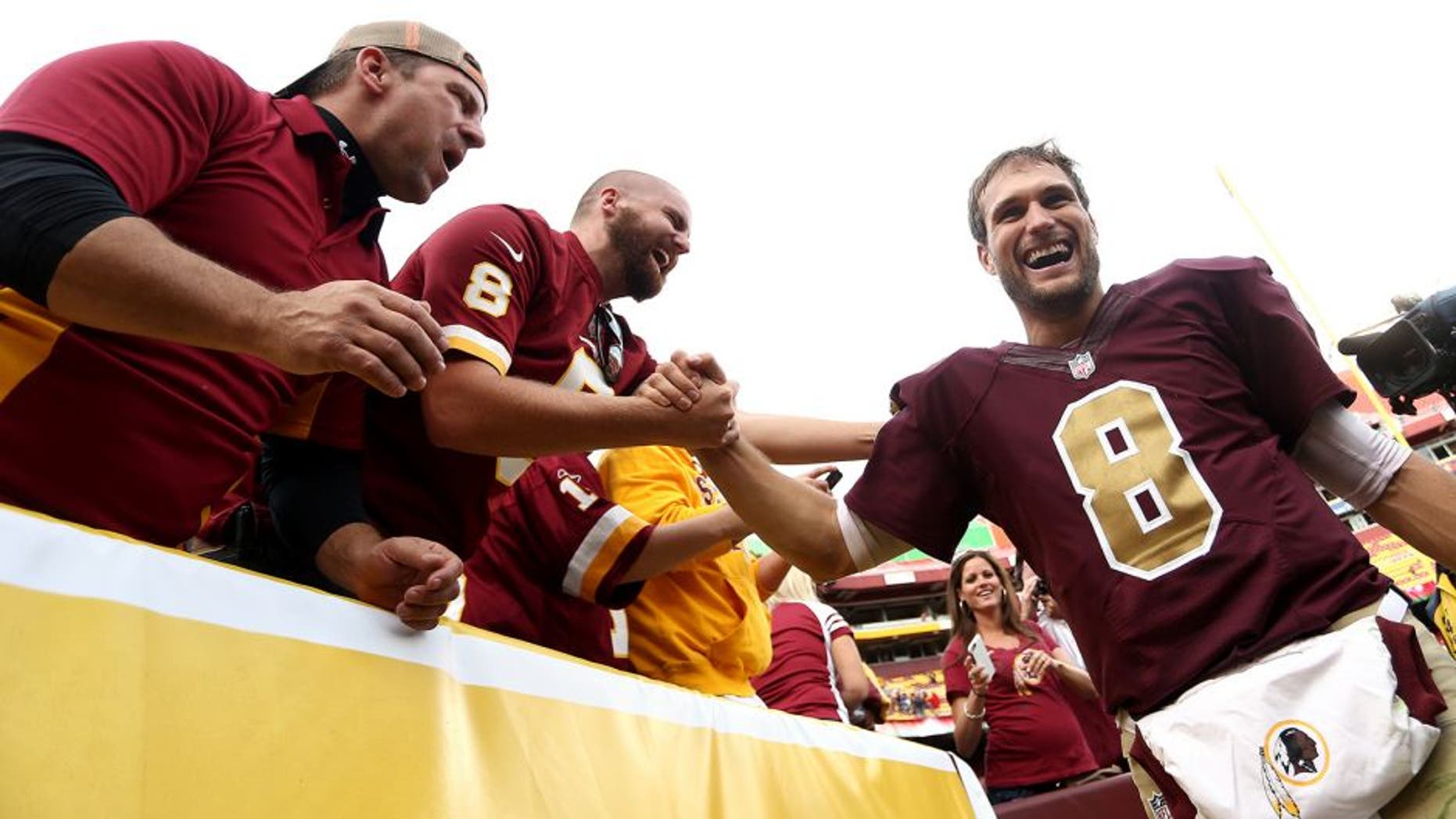 LANDOVER, MD - OCTOBER 25: Quarterback Kirk Cousins #8 of the Washington Redskins celebrates with fans after defeating the Tampa Bay Buccaneers 31-30 during a game at FedExField on October 25, 2015 in Landover, Maryland. (Photo by Matt Hazlett/Getty Images)