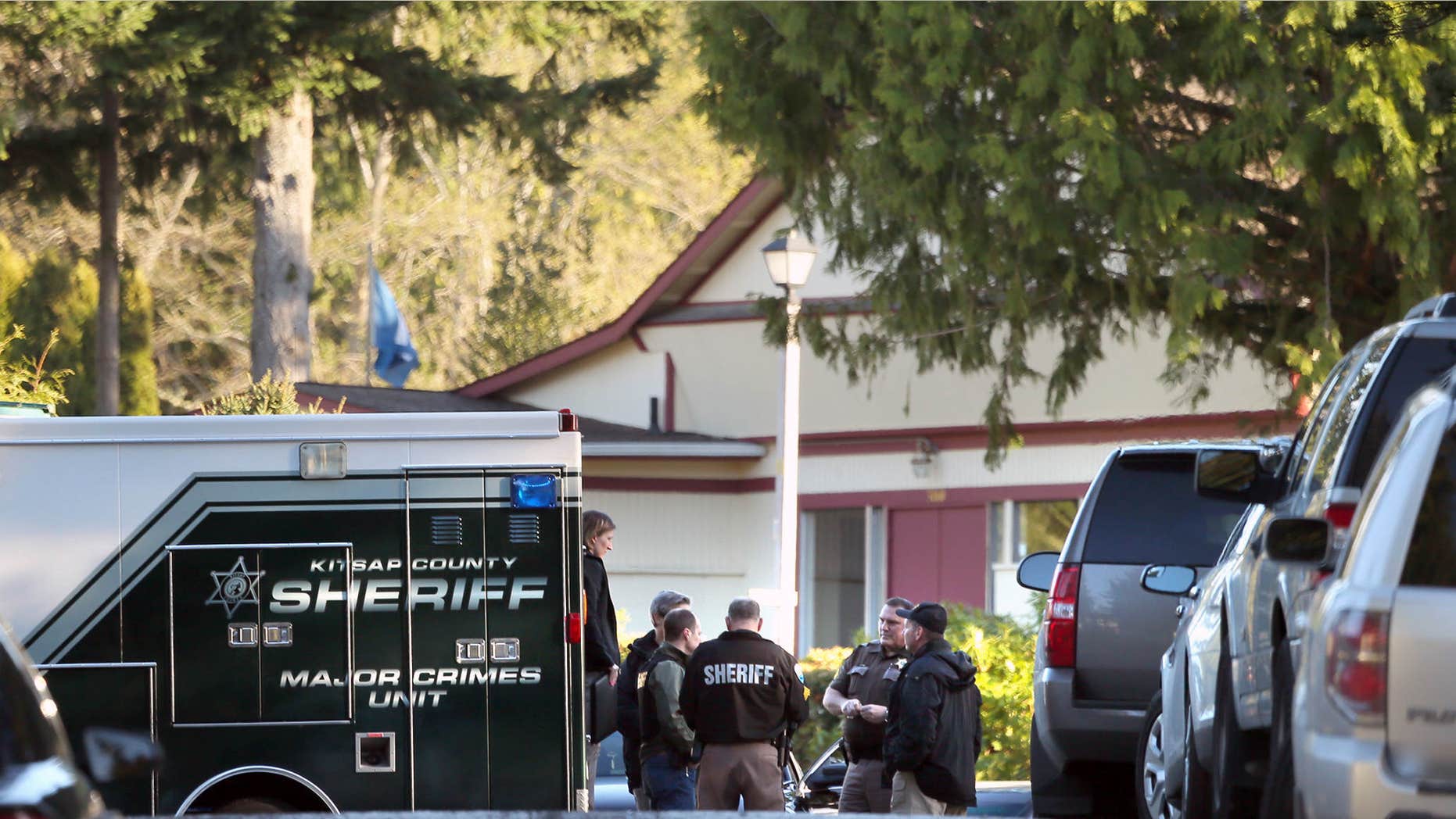 March 28, 2015: Kitsap County Sheriffs deputies and detectives gather to investigate the early Saturday morning shooting of three people, two fatal, at the Kariotis Community mobile home park off McWilliams Rd. in East Bremerton, Wash.