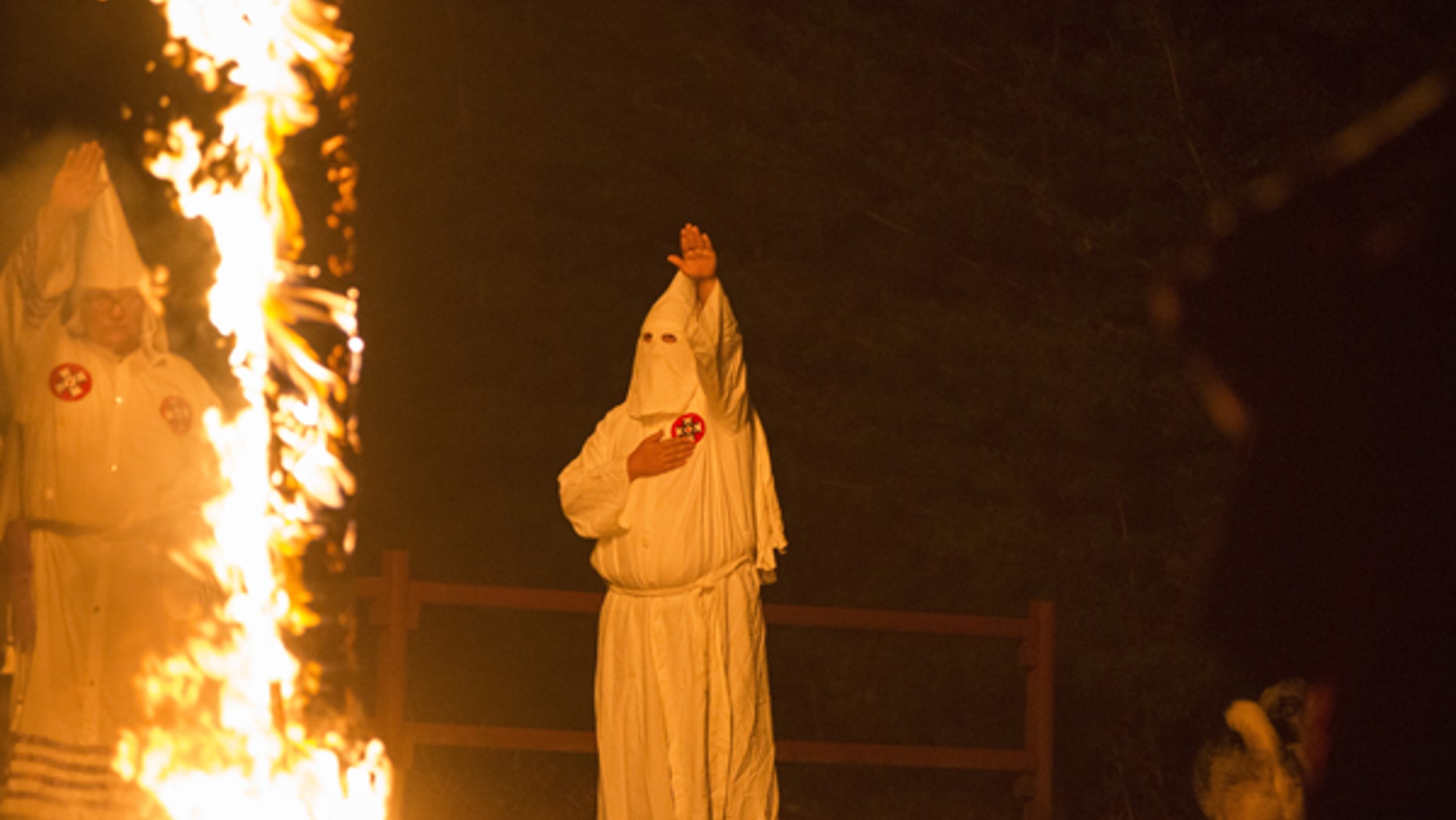 A member of the Ku Klux Klan salutes a lit cross during a cross lighting ceremony at a private residence in Henry County, Virginia, October 11, 2014. The Ku Klux Klan, which had about 6 million members in the 1920s, now has some 2,000 to 3,000 members nationally in about 72 chapters, or klaverns, according to the Southern Poverty Law Center, an organization that monitors extremist groups. REUTERS/Johnny Milano
PICTURE 31 OF 34 FOR WIDER IMAGE STORY "INSIDE THE KU KLUX KLAN"
SEARCH "MILANO KKK" FOR ALL PICTURES - GF10000160836