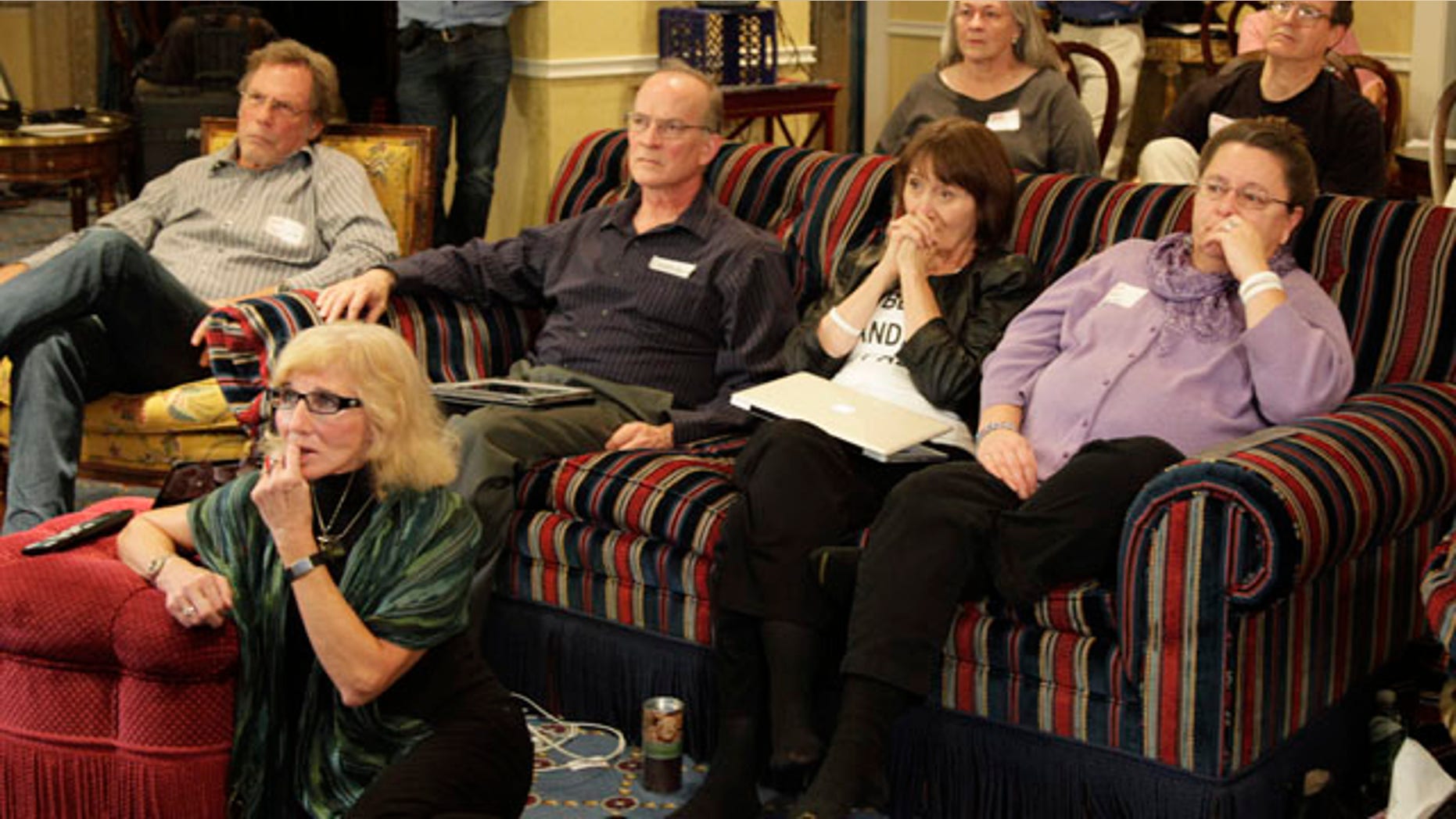 Supporters of Amanda Knox listen to Knox make a statement in Italian court on television in Seattle in the early morning hours of Monday, Oct. 3, 2011. Supporters of Knox are awaiting a verdict from an Italian court in the appeal of her conviction in the 2007 death of Knox's roommate that has garnered international headlines. (AP Photo/Ted S. Warren)