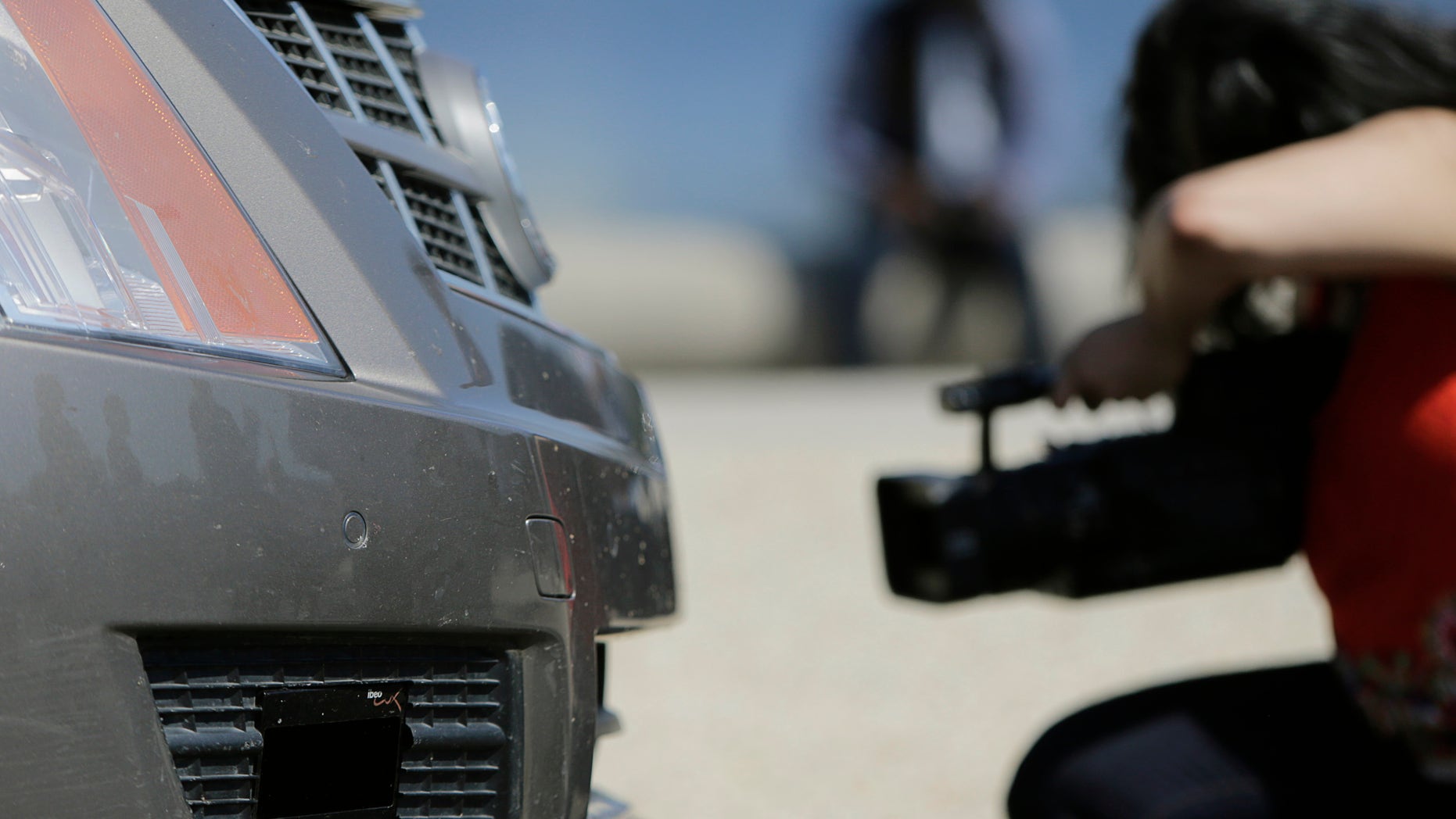File photo. A member of the media photographs the front end sensors of a 2011 Cadillac SRX autonomous car created by students and staff of Carnegie Mellon University in Washington June 24, 2014.