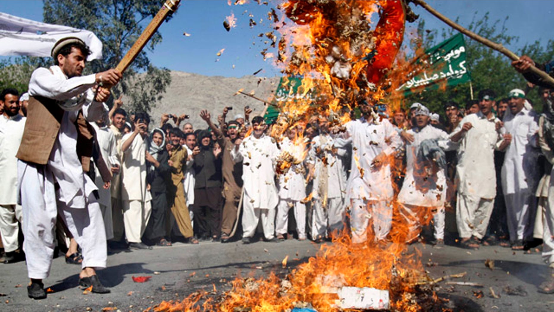 April 3, 2011: Afghan protestors burn an effigy of U.S. President Barack Obama during a demonstration in Jalalabad, Afghanistan. Afghan protests against the burning of a Koran in Florida entered a third day with a demonstration in the major eastern city Sunday, while the Taliban called on people to rise up, blaming government forces for any violence.