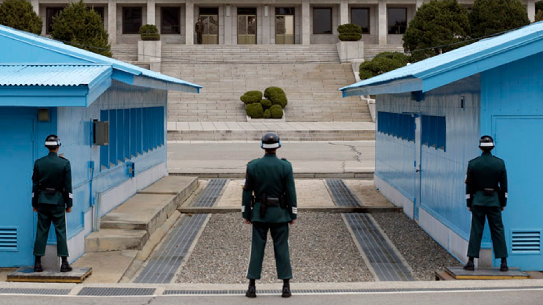 April 10, 2013: A North Korean soldier, center top, looks at the southern side as South Korean soldiers stand guard at the border village of Panmunjom, which has separated the two Koreas since the Korean War, in Paju, north of Seoul, South Korea. The prospect of a North Korean missile launch is "considerably high," South Korea's foreign minister told lawmakers Wednesday as Pyongyang prepared to mark the April 15 birthday of its founder, historically a time when it seeks to draw the world's attention with dramatic displays of military power.