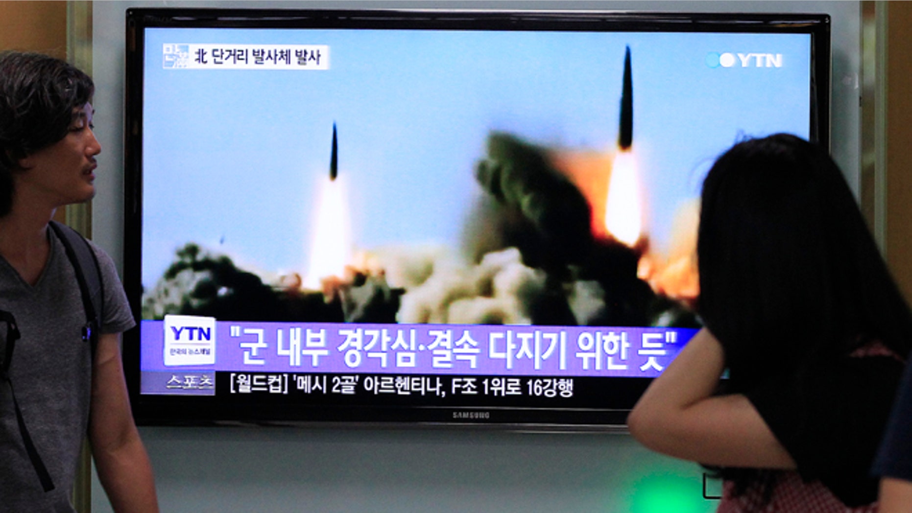 June 26, 2014: People watch a TV news program showing the missile launch conducted by North Korea, at Seoul Railway Station in Seoul, South Korea.