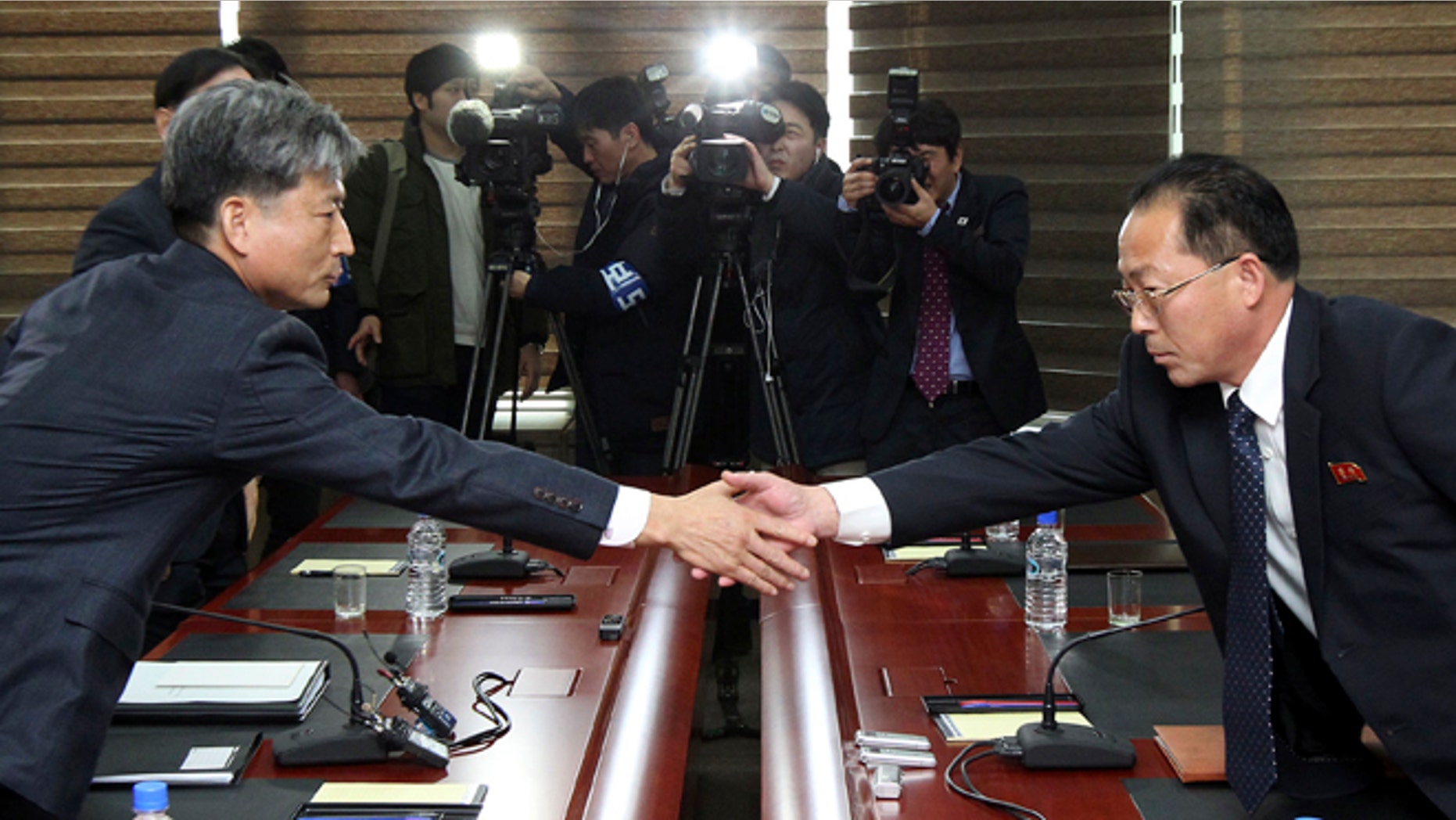 Dec. 11, 2015: Hwang Boogi, left, South Korea' vice minister of unification and the head negotiator for high-level talks with North Korea, shakes hands with his North Korean counterpart Jon Jong Su, right, before their meeting at the Kaesong Industrial Complex in Kaesong, North Korea.