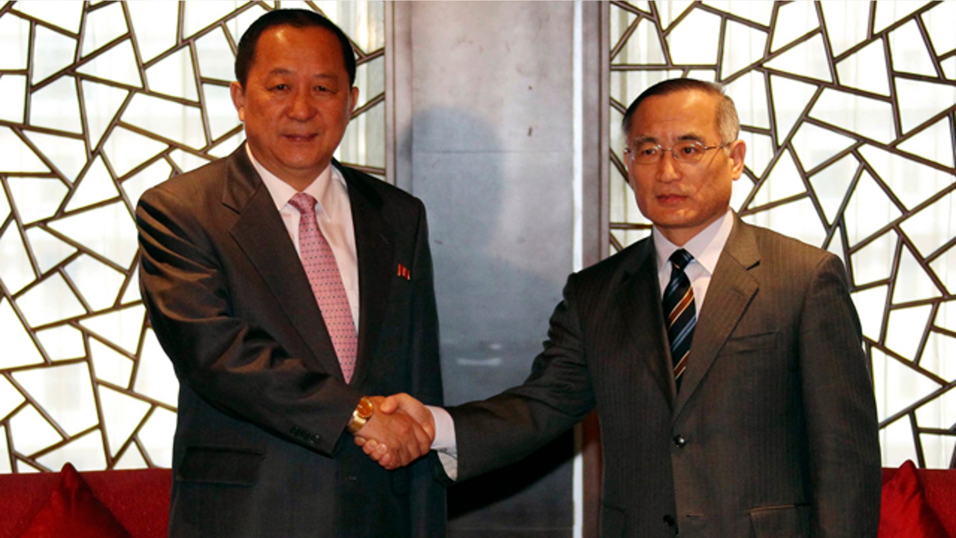 Sept. 21: South Korean nuclear envoy Wi Sung-lac, right, shakes hands with his North Korea's counterpart Ri Yong Ho at the private Chang An Club in Beijing, China.