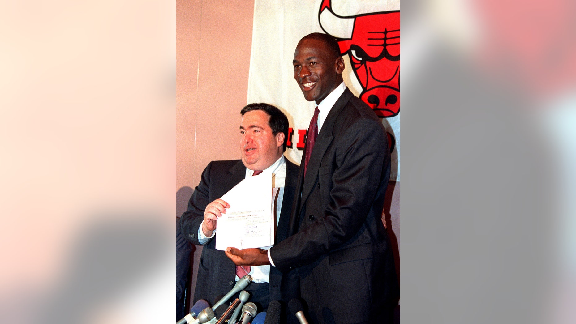 FILE - In this Sept. 21, 1988, file photo, Chicago Bulls' Michael Jordan, right, is all smiles after he signed a new contract with the NBA basketball team as general manager Jerry Krause looks on during a news conference in Chicago, Ill.