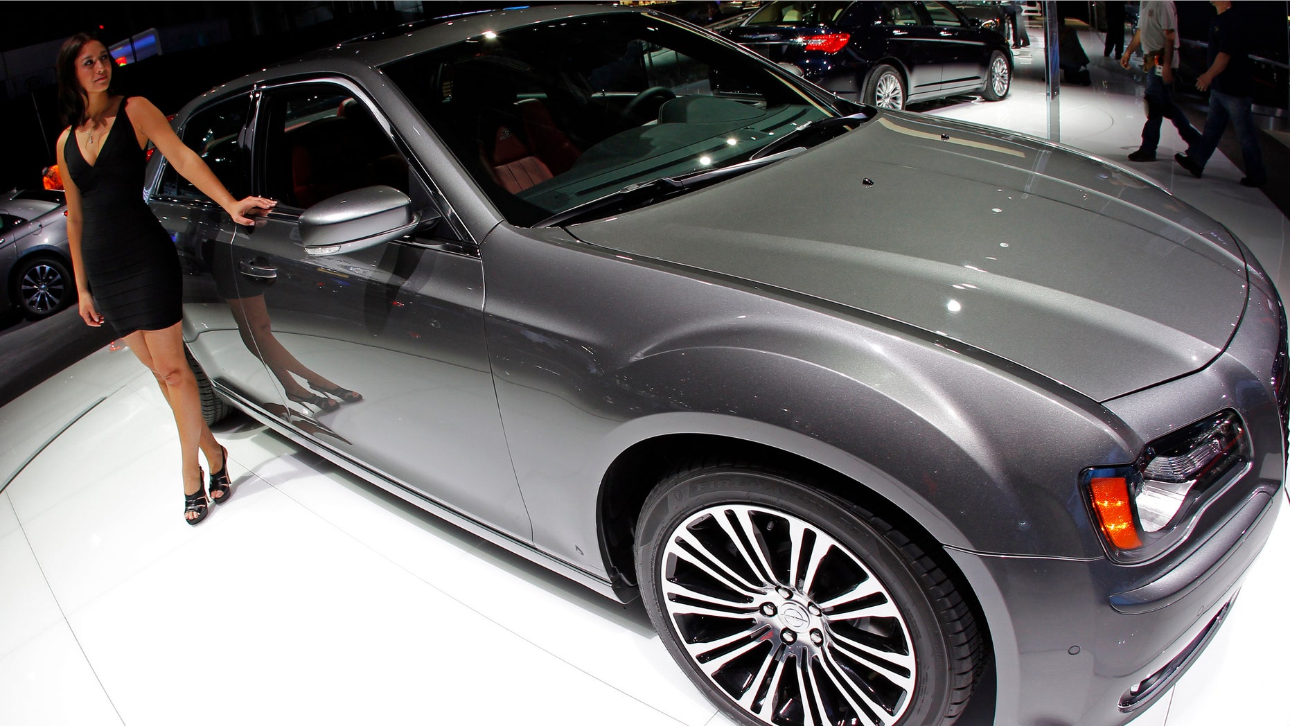 April 21, 2011: A model stands by a Chrysler 300 S on display at the New York International Auto Show in New York City