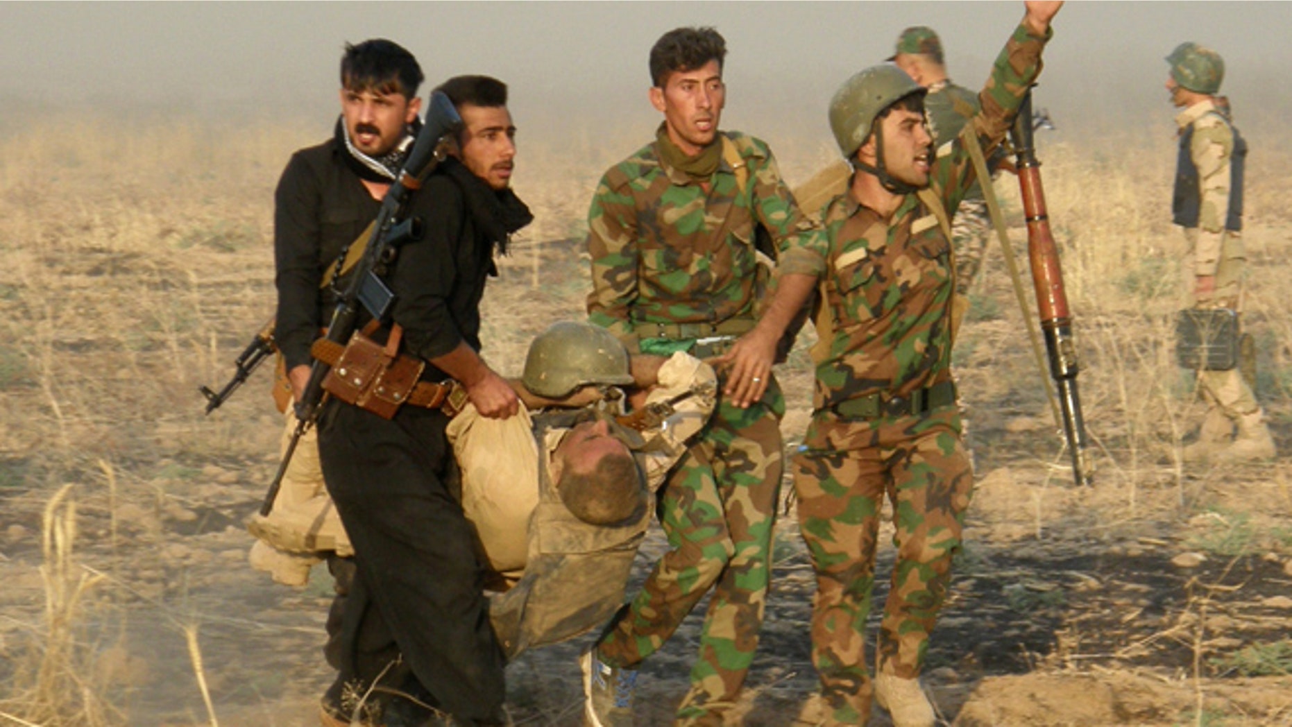 Aug. 26: An injured Kurdish officer is taken for treatment, during a military operation to regain control of some villages from Islamic State group fighters south of oil-rich city of Kirkuk.
