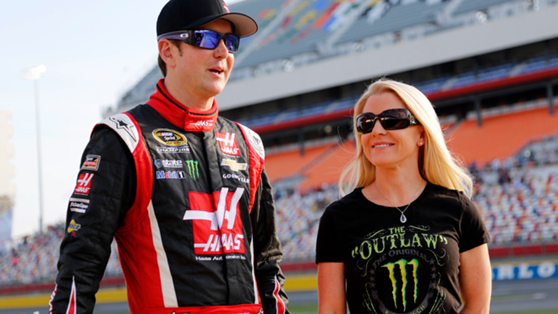 In this May 22, 2014, file photo, Kurt Busch, left, stands with Patricia Driscoll before qualifying for a NASCAR Sprint Cup series auto race at Charlotte Motor Speedway in Concord, N.C.