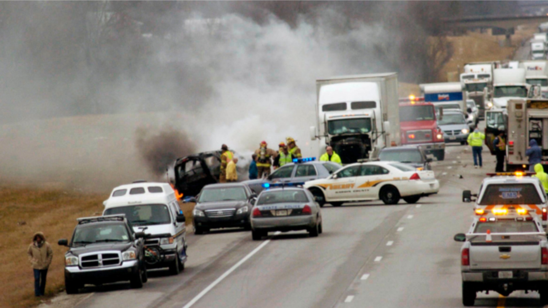 March 2, 2013: Emergency personnel work at the scene of a multi-vehicle wreck on Interstate 65 near the 82 mile marker north of Sonora, Ky.