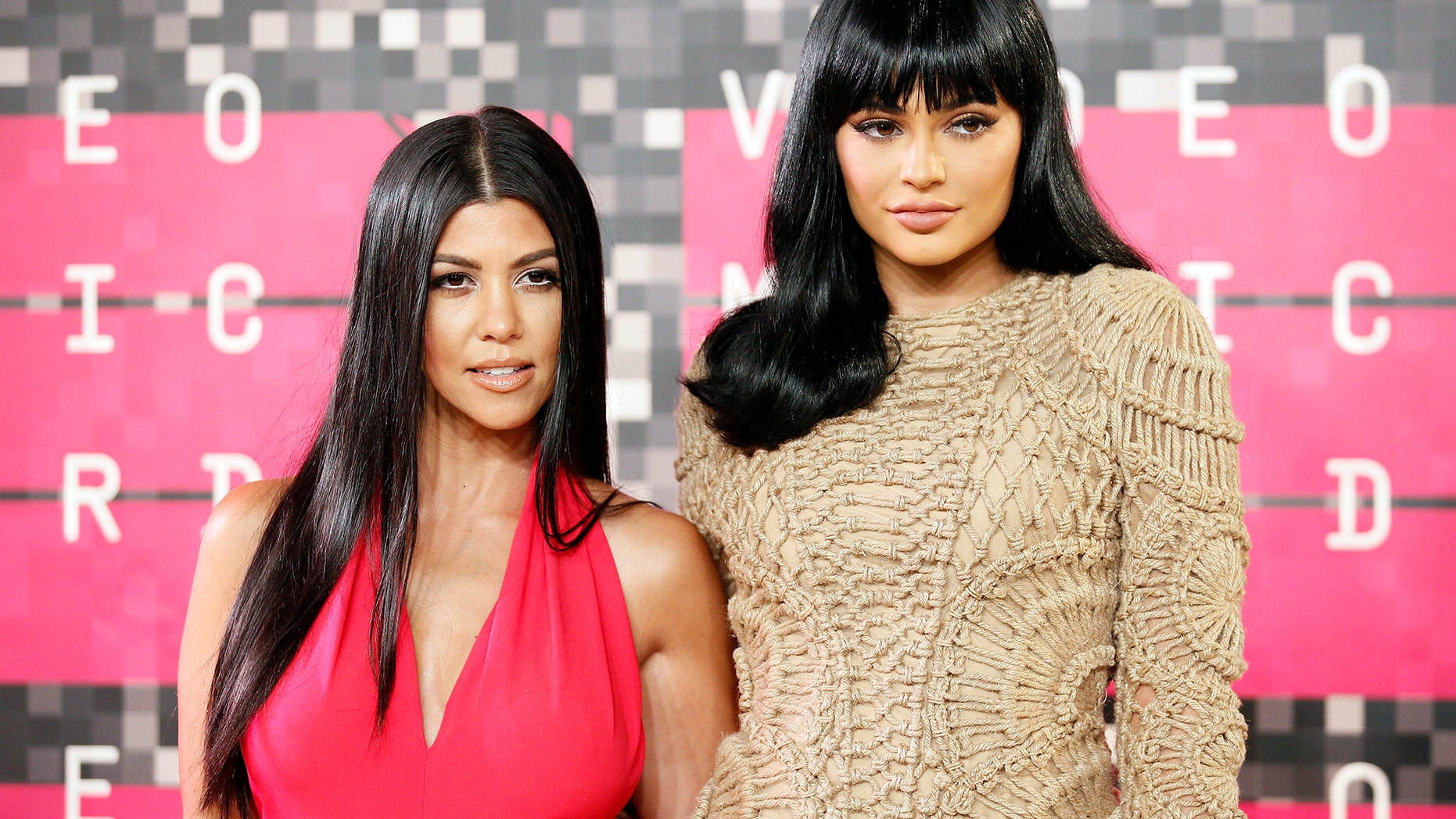 Reality television stars Kourtney Kardashian and Kylie Jenner arrive at the 2015 MTV Video Music Awards in Los Angeles, California, August 30, 2015.