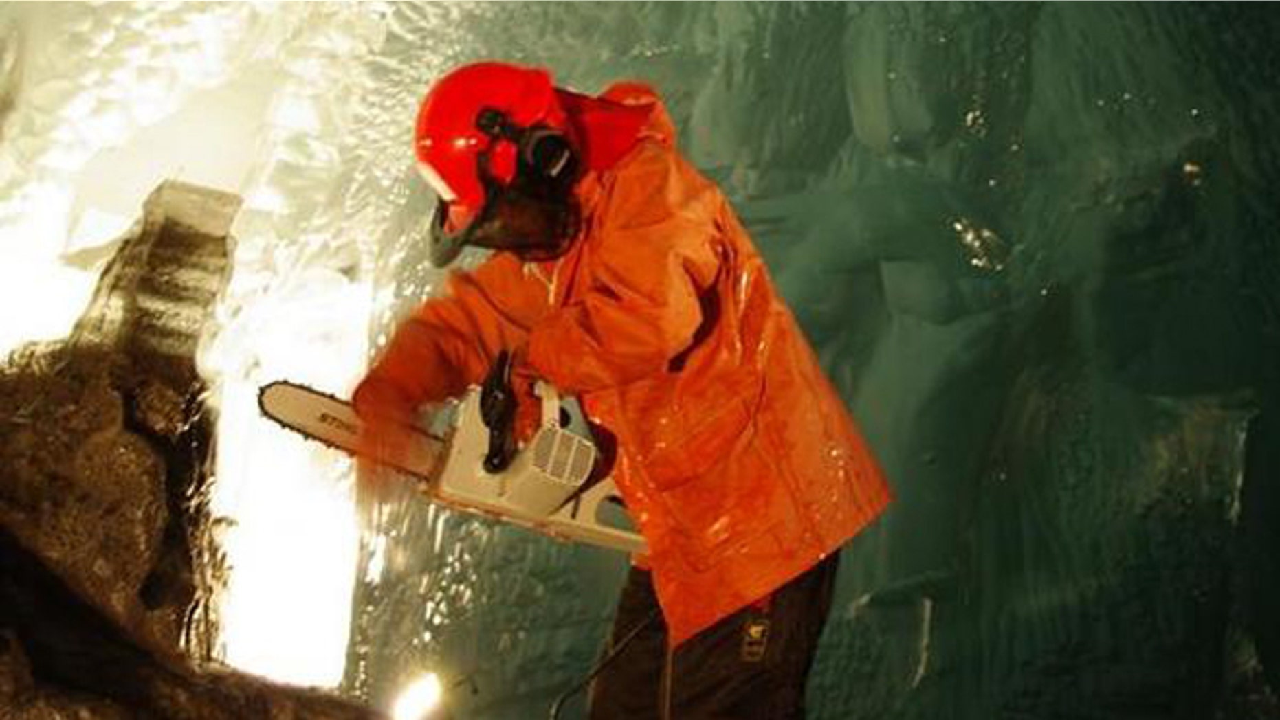 Researcher Miriam Jackson takes ice samples with a chainsaw under Norway's Svartisen glacier.