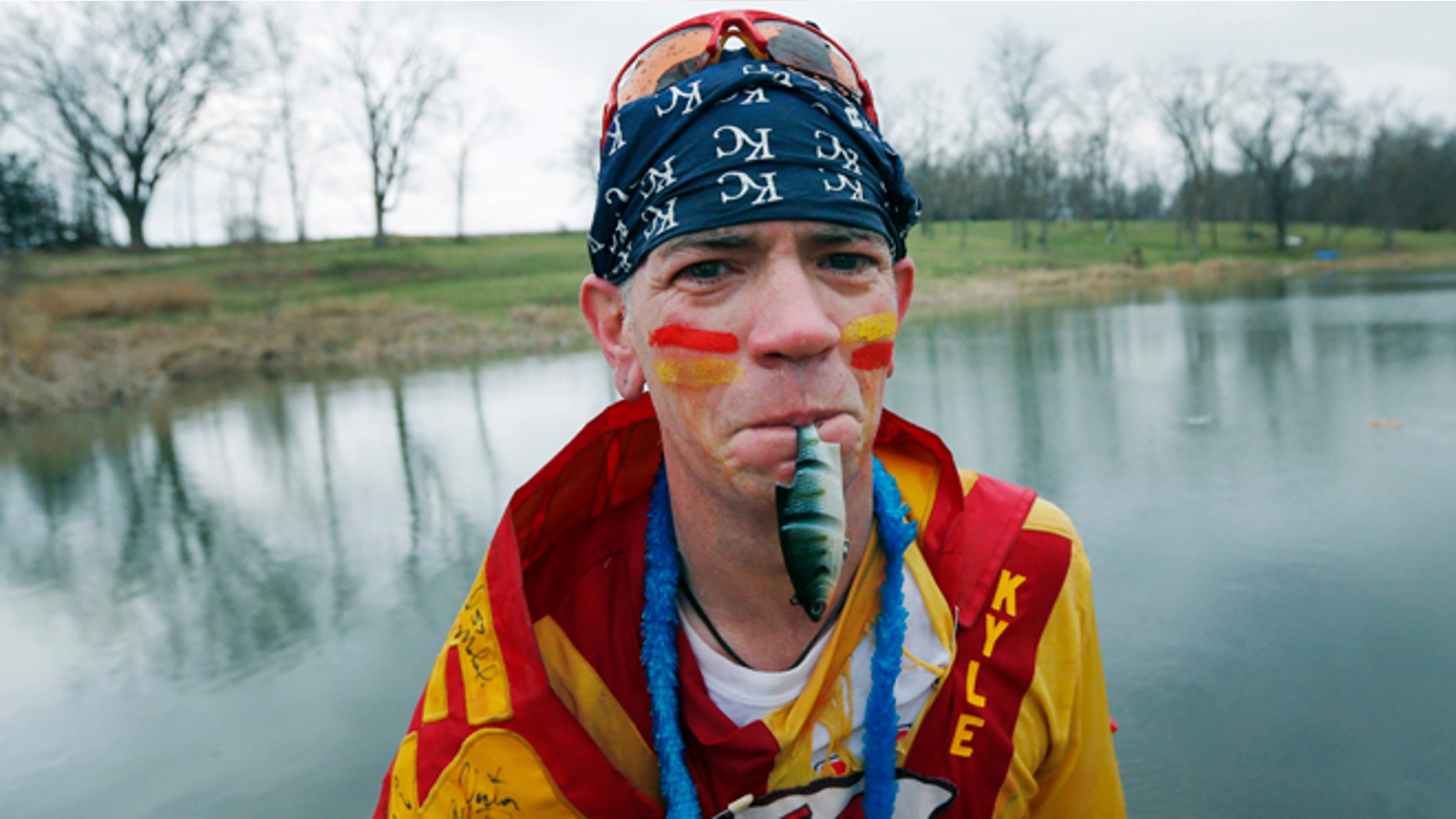 Apr. 4, 2014: Kansas City Chiefs fan Ty Rowton, known as XFactor, exits the water with a toy fish in his mouth after taking a Plunge for Landon in a farm pond near Bonner Springs, Kan.