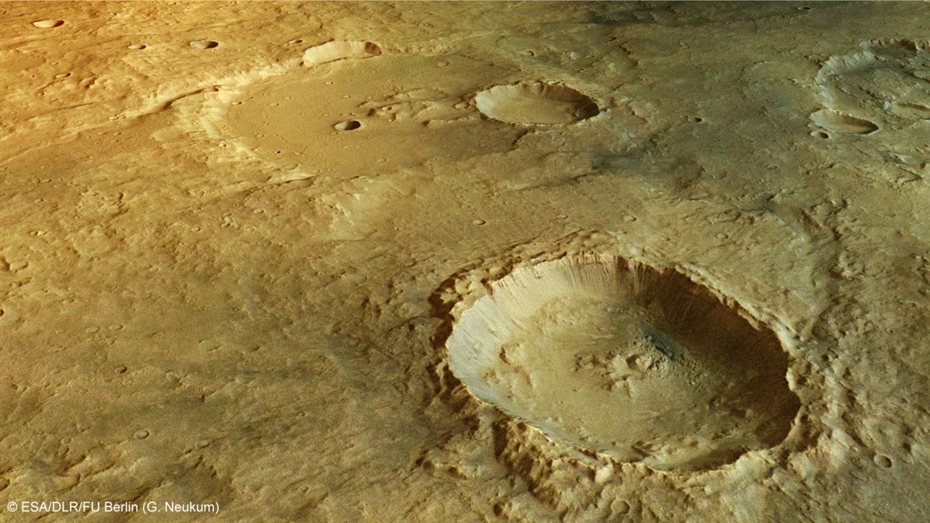 One of the deepest craters in Mars' Tagus Valles region lies in the foreground of this perspective view. Numerous landslides have occurred within this crater, leaving grooves in the wall as material slumped to the floor below.