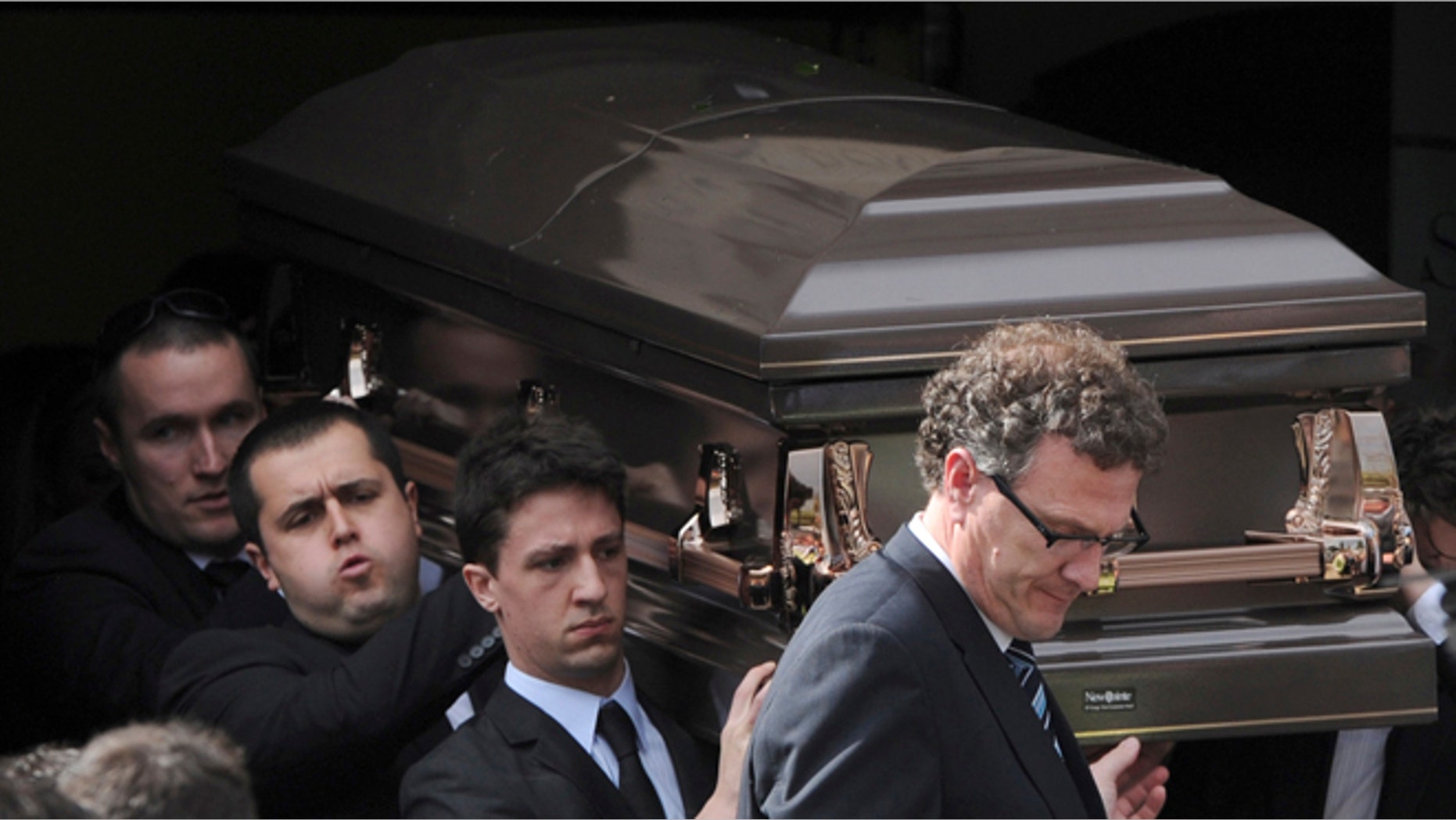 Aug. 28, 2013: Pallbearers carry the coffin of Christopher Lane to the funeral hearse at St. Therese's Church in Melbourne, Australia. Lane died Aug. 16 in Duncan, Oklahoma, and police say three teenagers targeted him at random to break up the monotony of an Oklahoma summer. (AP/AAP Image, Julian Smith)