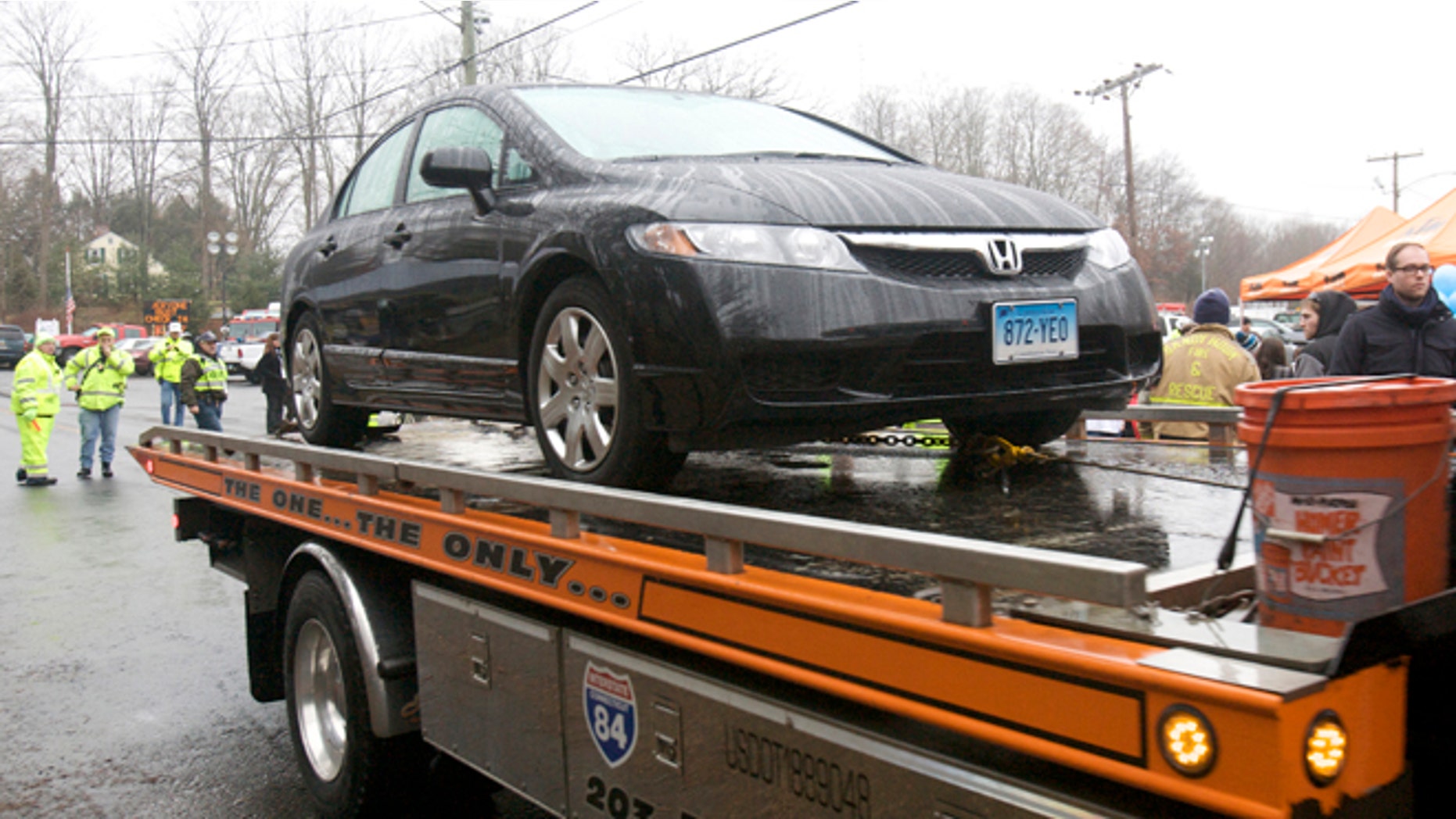Dec. 16, 2012: The car driven by Connecticut school shooter Adam Lanza is towed from Sandy Hook Elementary School in Newtown, Conn.