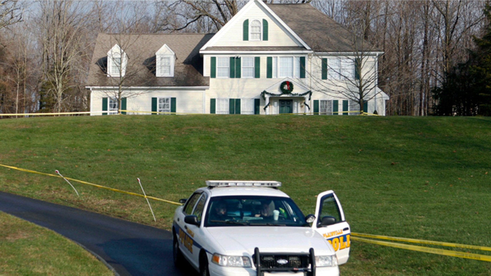 Dec. 18, 2012: A police cruiser sits in the driveway of the home of Nancy Lanza in Newtown, Conn., the Colonial-style house where she had lived with her son Adam Lanza. (AP)