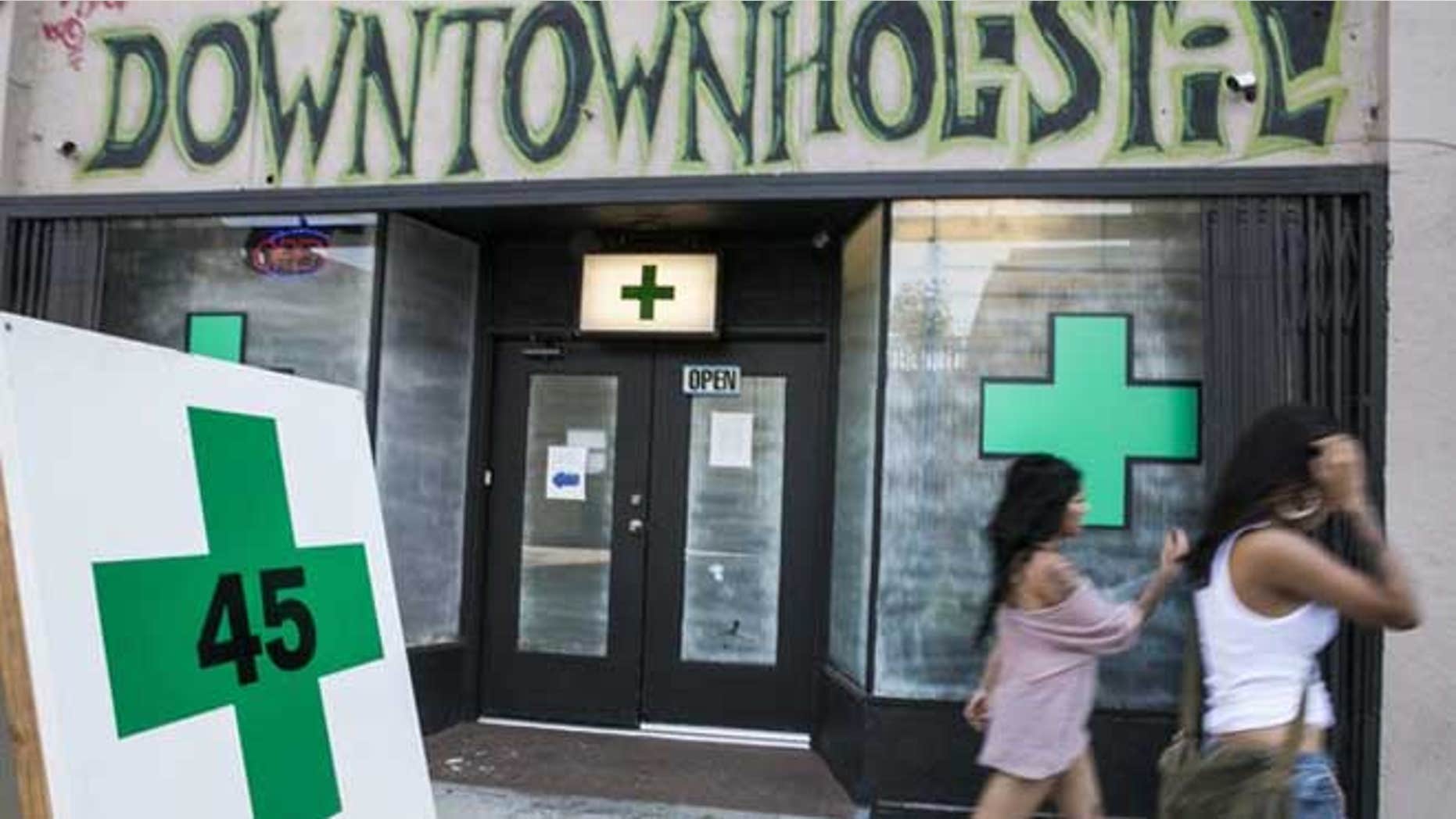 July 24, 2012: Pedestrians walk past a medical marijuana dispensary in the Echo Park area of Los Angeles.
