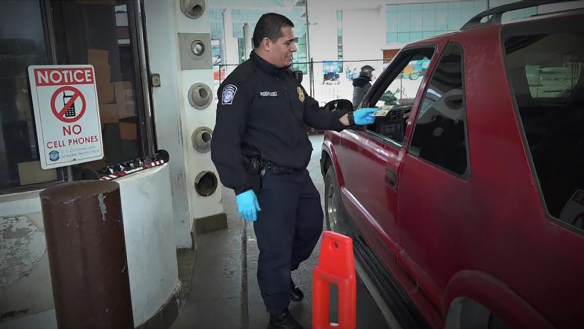 A border patrol officer inspecting entry documents at Laredo Port of Entry in Texas.