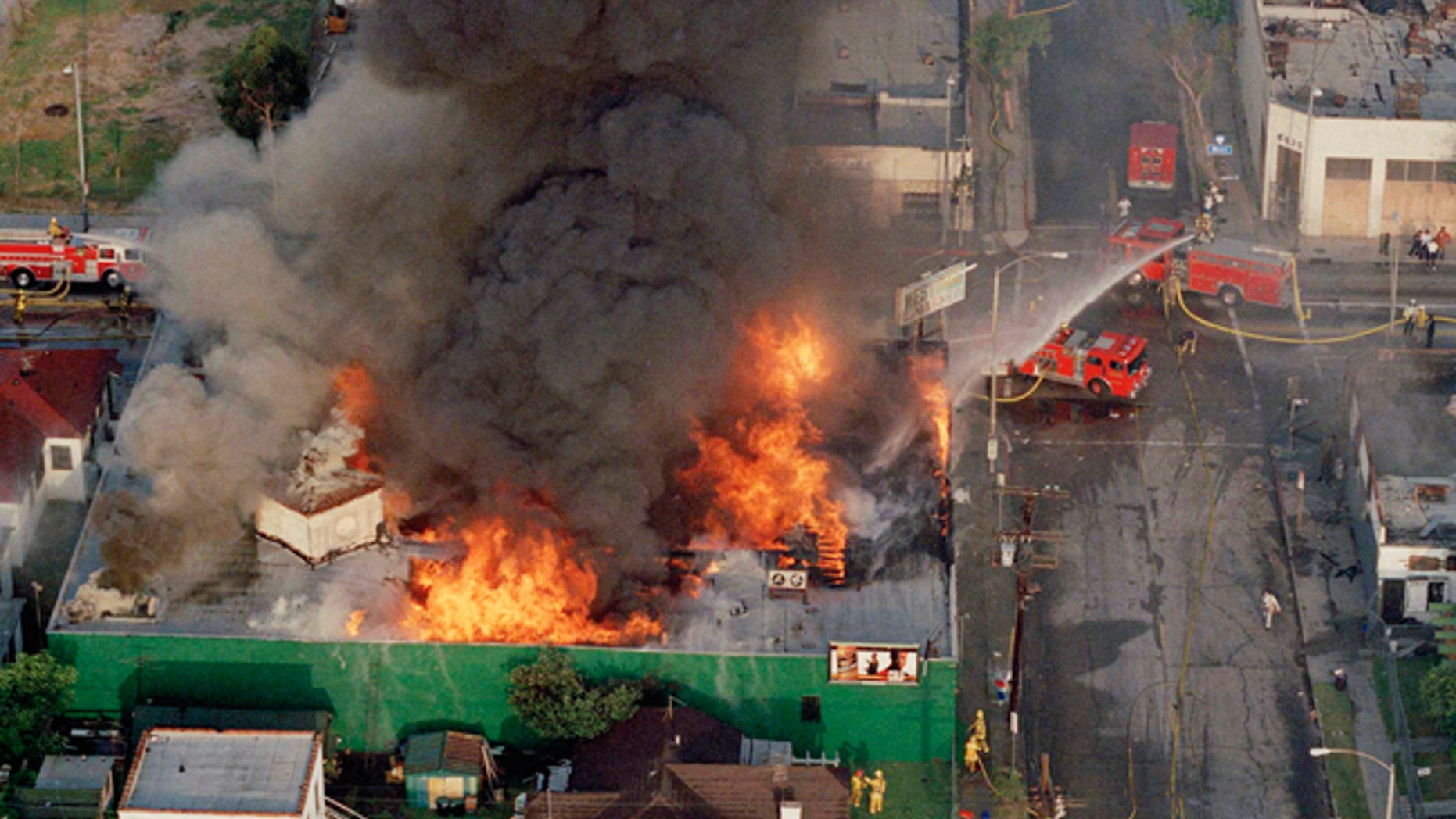 FILE - In this April 30, 1992 file photo, a fire burns out of control at the corner of 67th Street and West Boulevard in South Central Los Angeles. On April 29, 1992, four white police officers were declared innocent in the beating of black motorist Rodney King, and Los Angeles erupted in deadly riots. Three days later, 55 people were dead and more than 2,000 injured. Fires and looting had destroyed $1 billion worth of property. (AP Photo/Paul Sakuma)