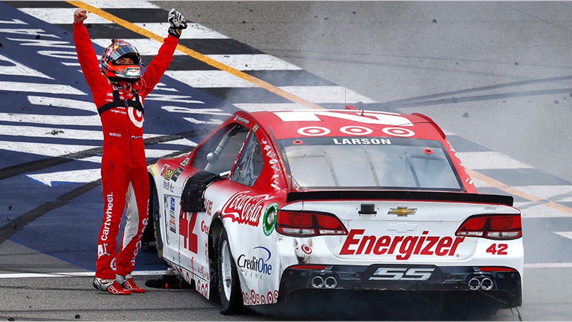 Kyle Larson celebrates winning a NASCAR Cup Series auto race in Brooklyn, Mich., Sunday, Aug. 13, 2017. (AP Photo/Paul Sancya)