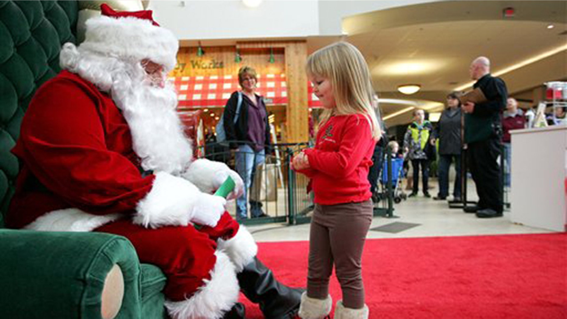Dec. 23, 2010: Emma Schlichtmann, 3, of Potosi, Wis., tells Santa all the things she wants for Christmas while visiting him at a shopping mall in Dubuque, Iowa.