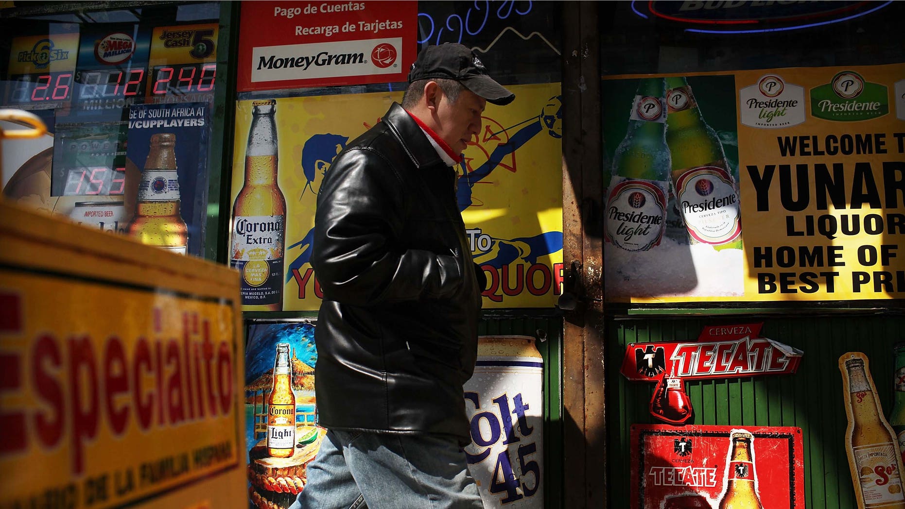 UNION CITY, NJ - MARCH 28: A man walks by adds in Spanish outside of a bodega on March 28, 2011 in Union City, New Jersey. Union City New Jersey, one of the stateÂs largest cities, has a population of Hispanic or Latino origin of over 80%. According to the new 2010 Census Bureau statistics reported last Thursday, the Hispanic population in the United States has grown by 43% in the last decade, surpassing 50 million and accounting for about 1 out of 6 Americans. (Photo by Spencer Platt/Getty Images)