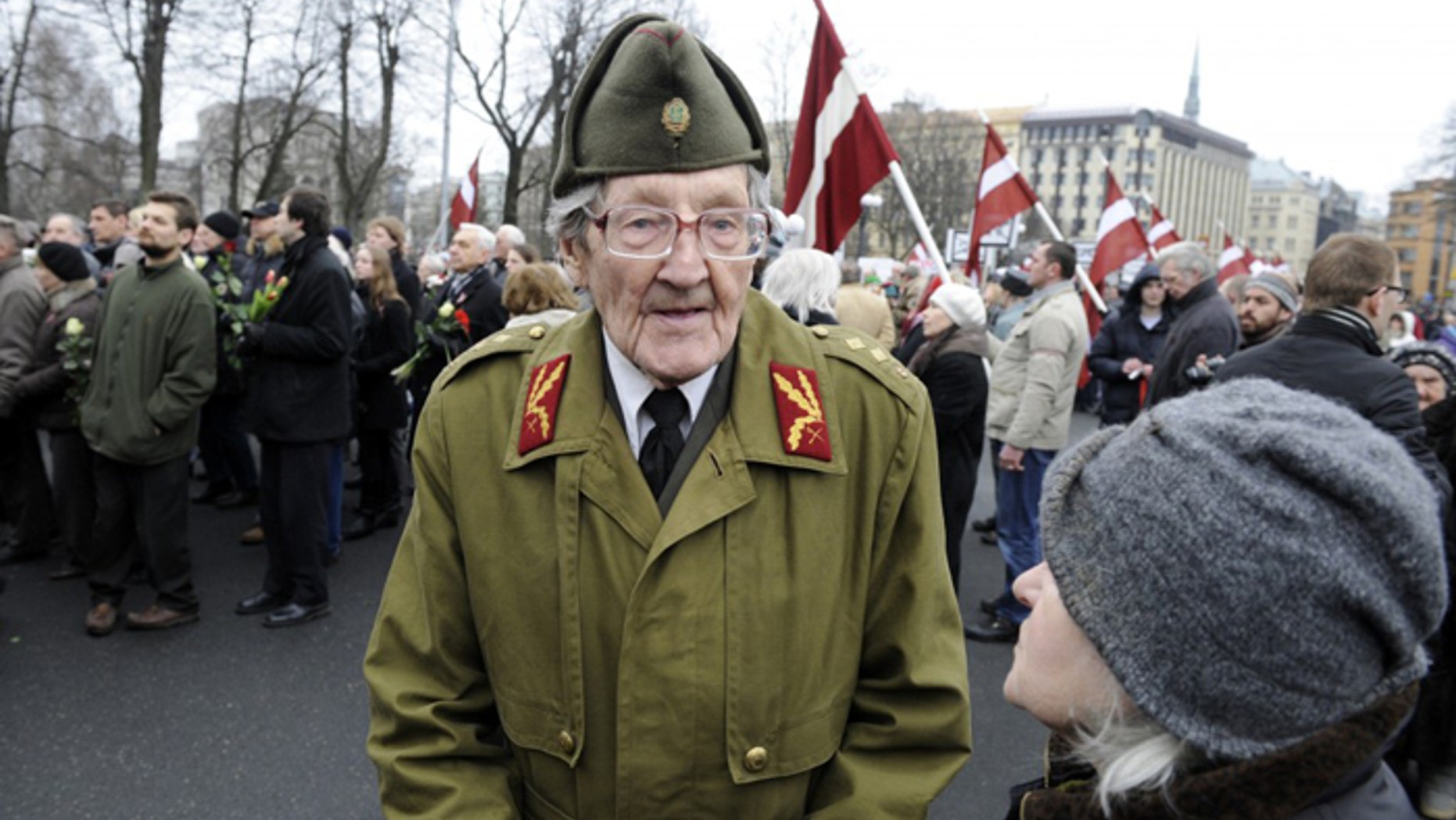 An elderly Latvian takes part in a ceremony to honor soldiers who fought in a Waffen SS unit during World War II, in Riga, Latvia, last year. (AP/Roman Koksarov)