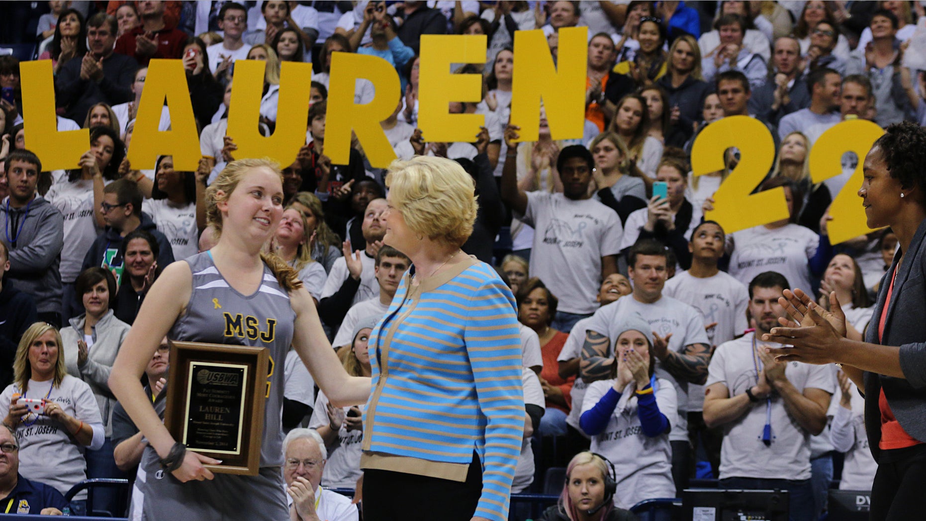 Nov. 2, 2014: Mount St. Joseph's Lauren Hill hugs Pat Summit after receiving the Pat Summitt Award during halftime of her first NCAA college basketball game against Hiram University at Xavier University in Cincinnati on Sunday
