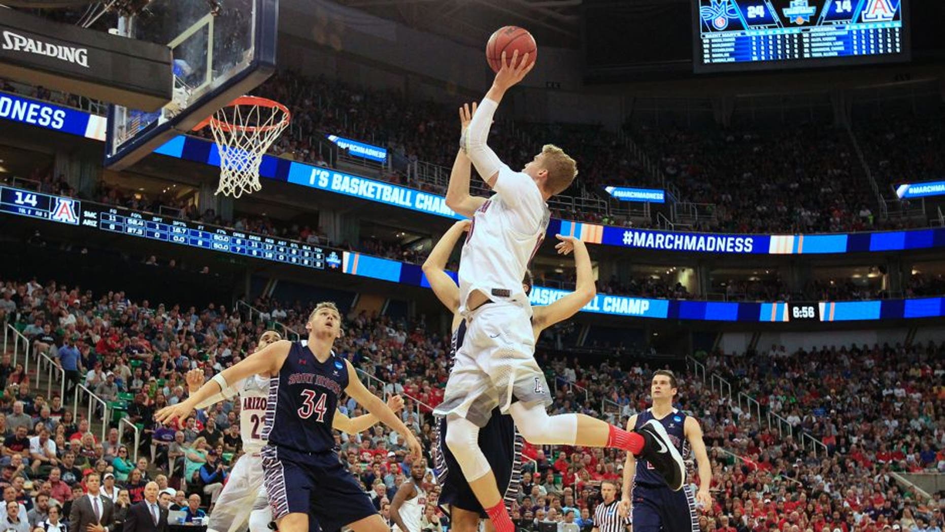 Arizona forward Lauri Markkanen (10) shoots the ball as Saint Mary's center Jock Landale (34) blocks out for the rebound during the first half of a second-round college basketball game in the men's NCAA Tournament Saturday, March 18, 2017, in Salt Lake City. (AP Photo/George Frey)