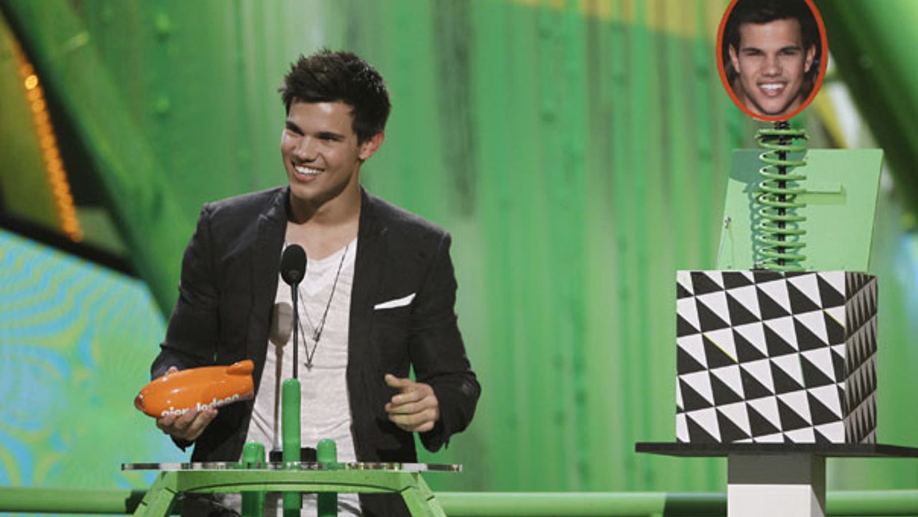 March 27: Taylor Lautner accepts the award for favorite movie actor at Nickelodeon's 23rd Annual Kids' Choice Awards. (AP)