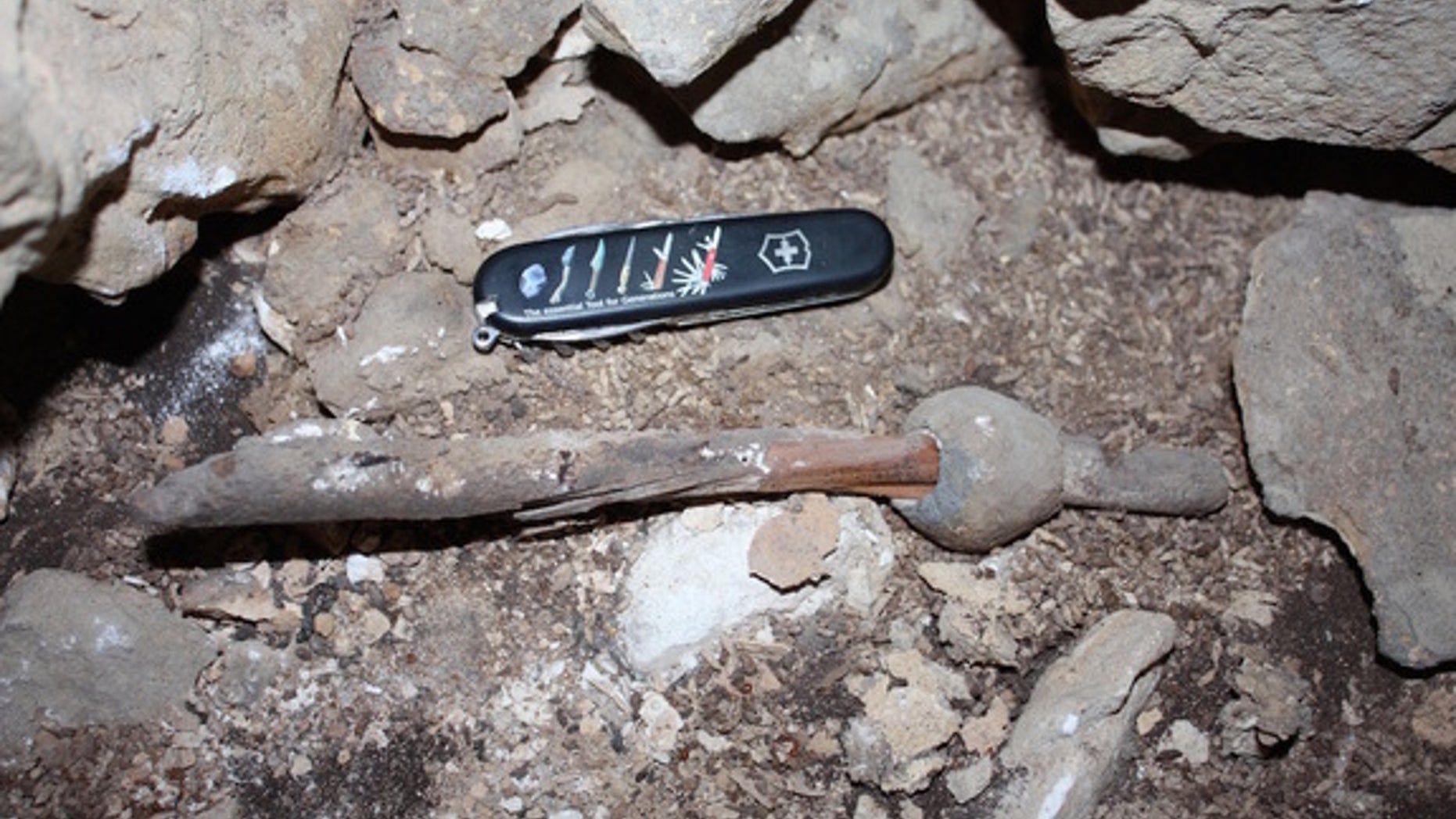 The ancient lead and wood artifact isn't much larger than a modern pocketknife.