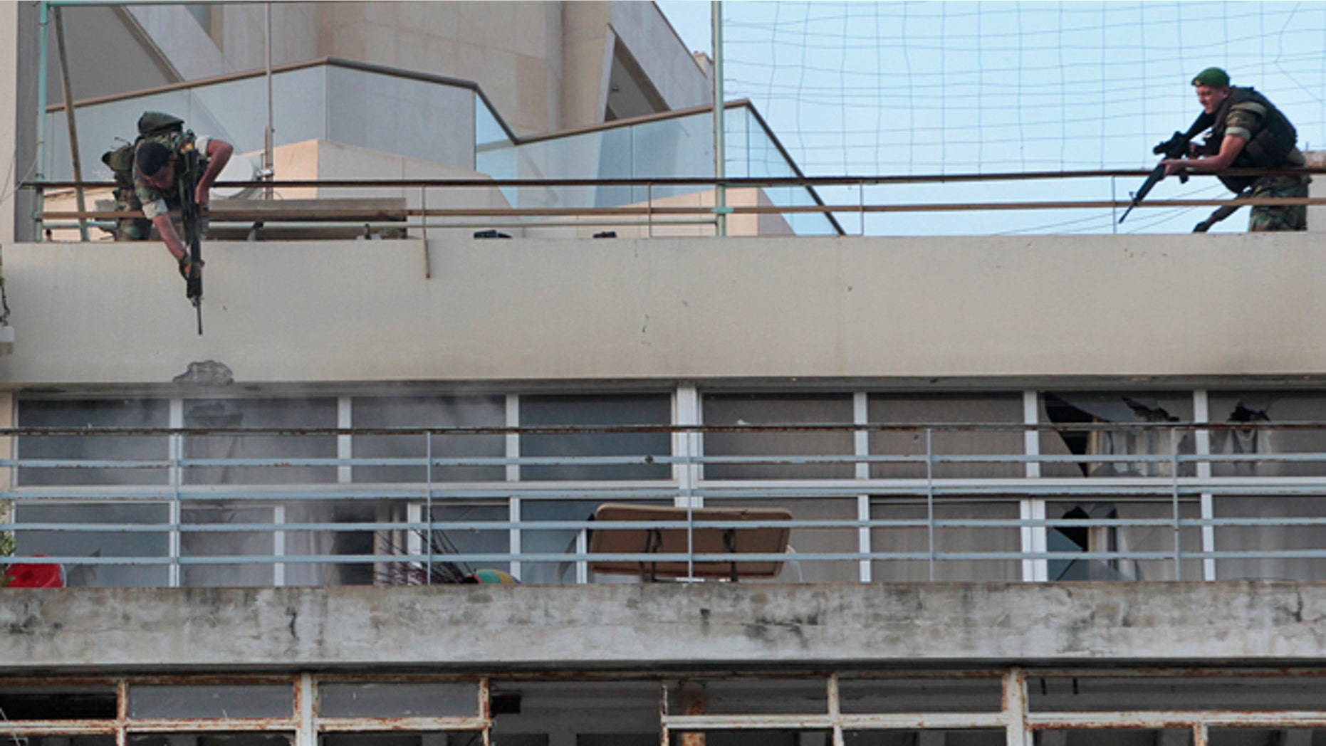 May 24, 2012: Lebanese army soldiers, fire their weapons on the apartment balcony of a Syrian gunman who had engaged in an hours-long shootout with the security forces, in Beirut, Lebanon.