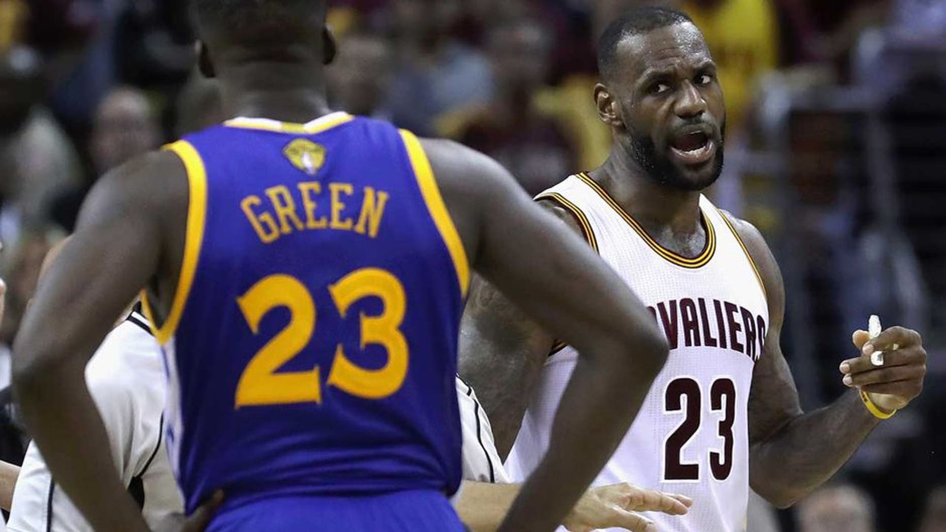 CLEVELAND, OH - JUNE 10: LeBron James #23 of the Cleveland Cavaliers and Draymond Green #23 of the Golden State Warriors exchange words during a time out during the fourth quarter in Game 4 of the 2016 NBA Finals at Quicken Loans Arena on June 10, 2016 in Cleveland, Ohio. NOTE TO USER: User expressly acknowledges and agrees that, by downloading and or using this photograph, User is consenting to the terms and conditions of the Getty Images License Agreement. (Photo by Ronald Martinez/Getty Images)
