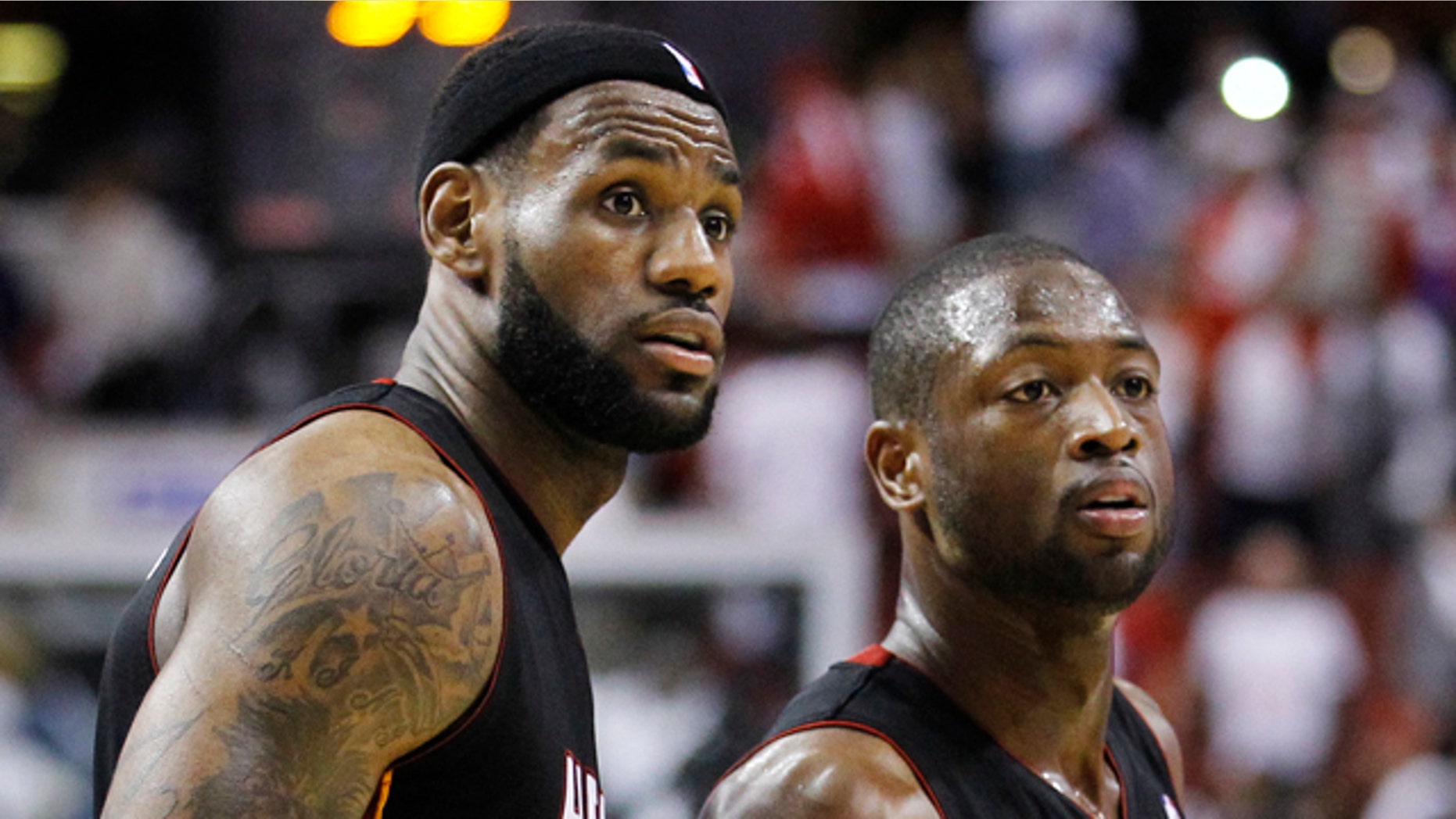 April 21: Miami Heat's LeBron James, left, and Dwyane Wade direct their attention toward the bench in the closing seconds of Game 3 of a first-round NBA playoff basketball series with the Philadelphia 76ers in Philadelphia. Miami won 100-94. (AP)