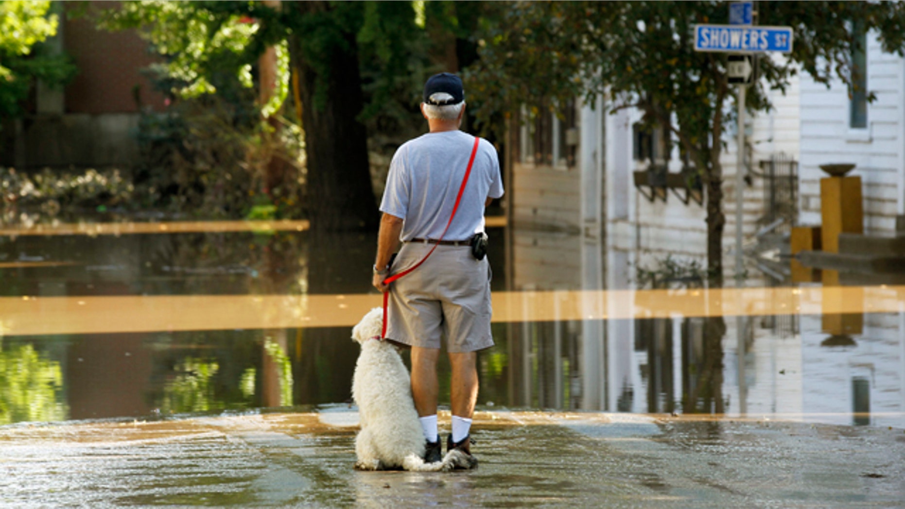 Sept. 10: John Wimer, and his dog Carlie, look at his neighborhood in the Shipoke area after flooding caused by the remnants of Tropical Storm Lee in Harrisburg, Pa.
