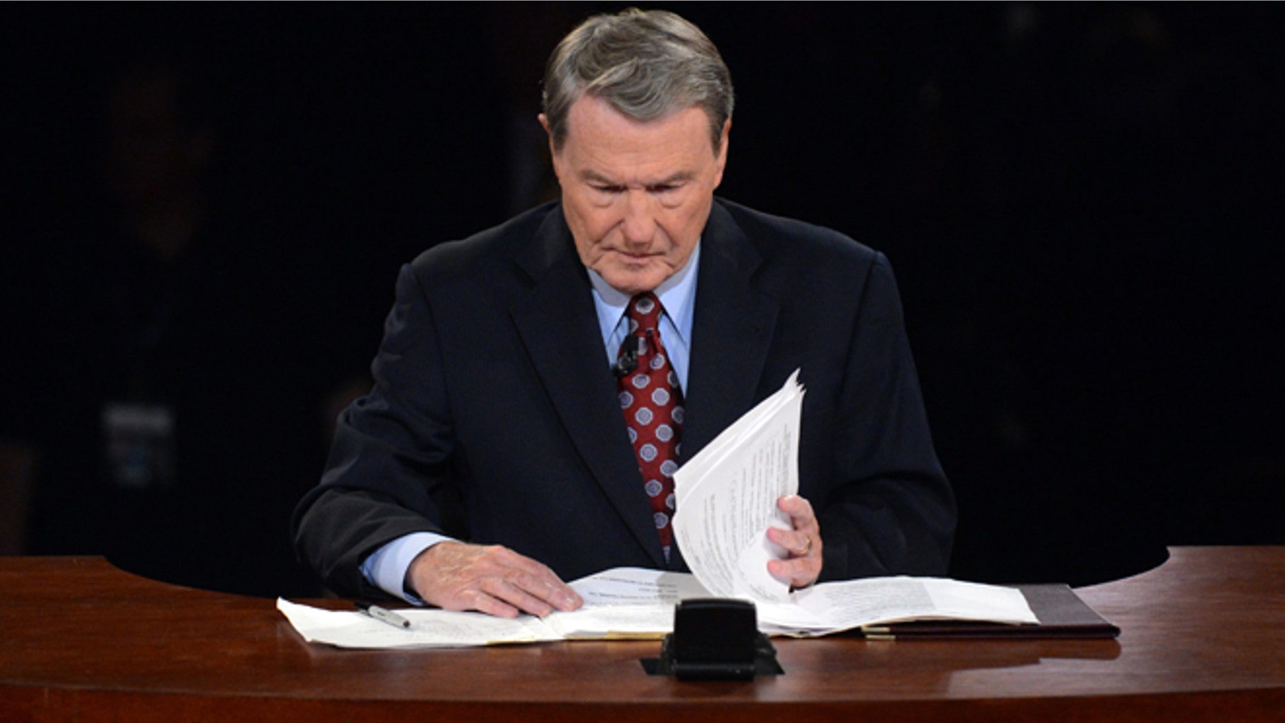 Oct. 3, 2012: Moderator Jim Lehrer looks over his notes before the first presidential debate.