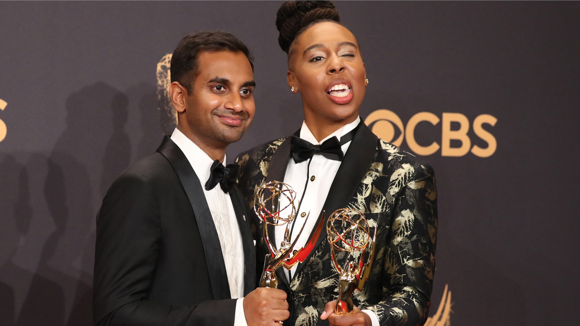 Aziz Ansari (L) and Lena Waithe pose with the Emmy for Outstanding Writing for a Comedy Series for "Master of None."