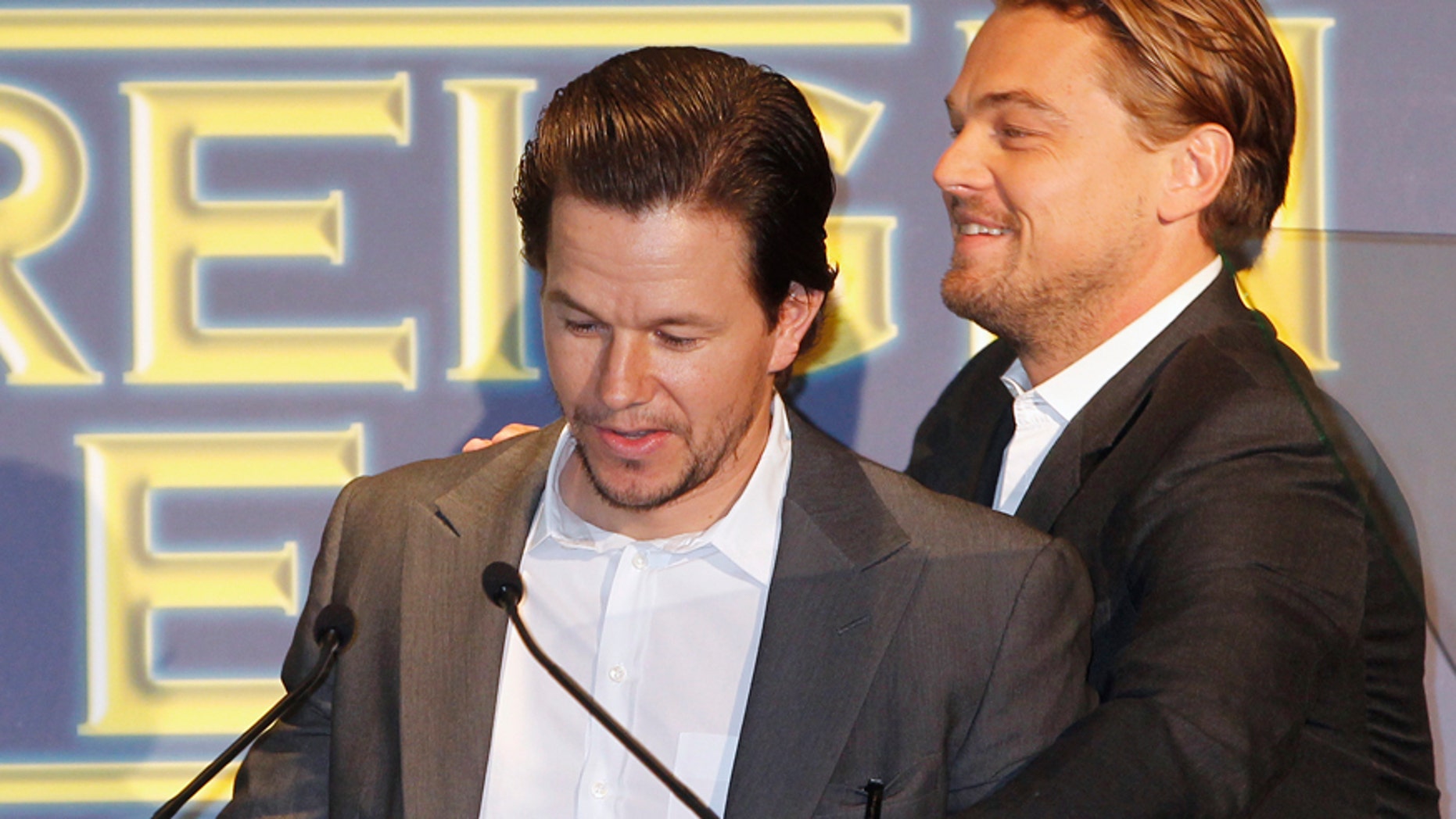Actors Mark Wahlberg (L) and Leonardo DiCaprio are seen at the podium during the Hollywood Foreign Press Association's (HFPA) Annual Installation Luncheon in Beverly Hills, California August 4, 2011.