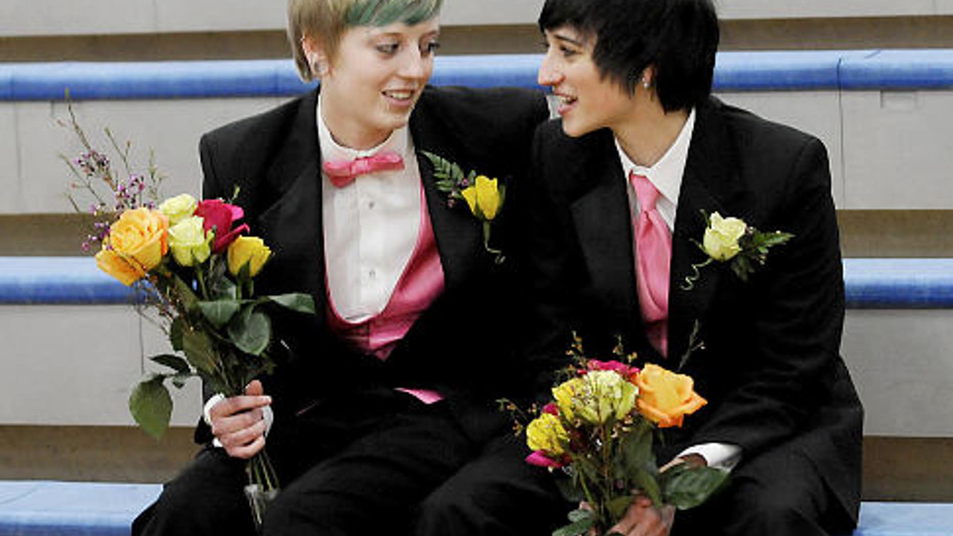 Desiree Shelton, left, and Sarah Lindstrom visit on the bleachers prior to the Royalty Court procession at the Snow Days Pep Fest at Champlin Park High School Monday, Jan. 31, 2011 in Champlin, Minn.