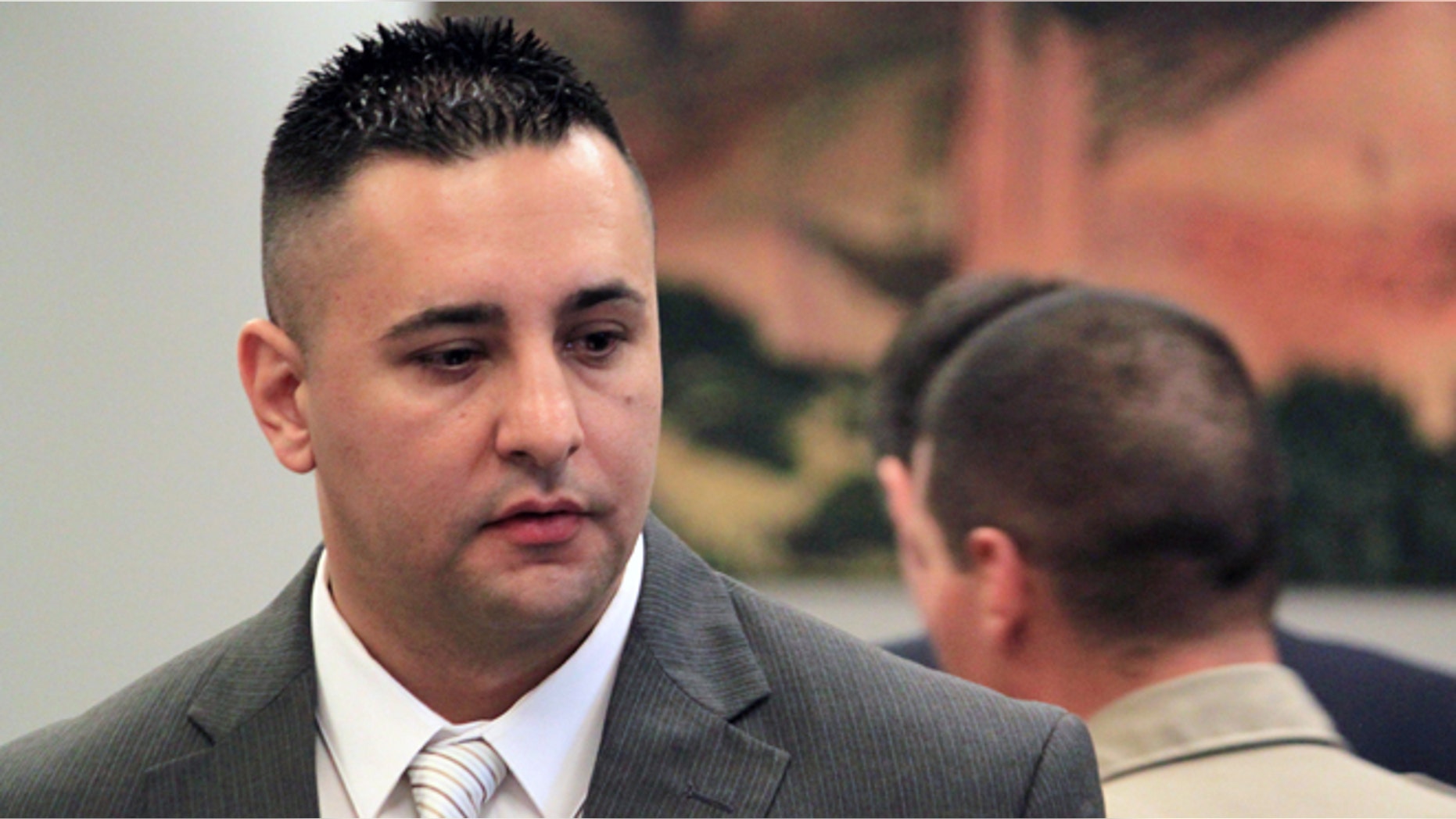 June 10, 2013: Former Albuquerque Police Officer Levi Chavez prepares to leave the courtroom following opening statements in his trial in Bernalillo, N.M. (AP/Susan Montoya Bryan, File)